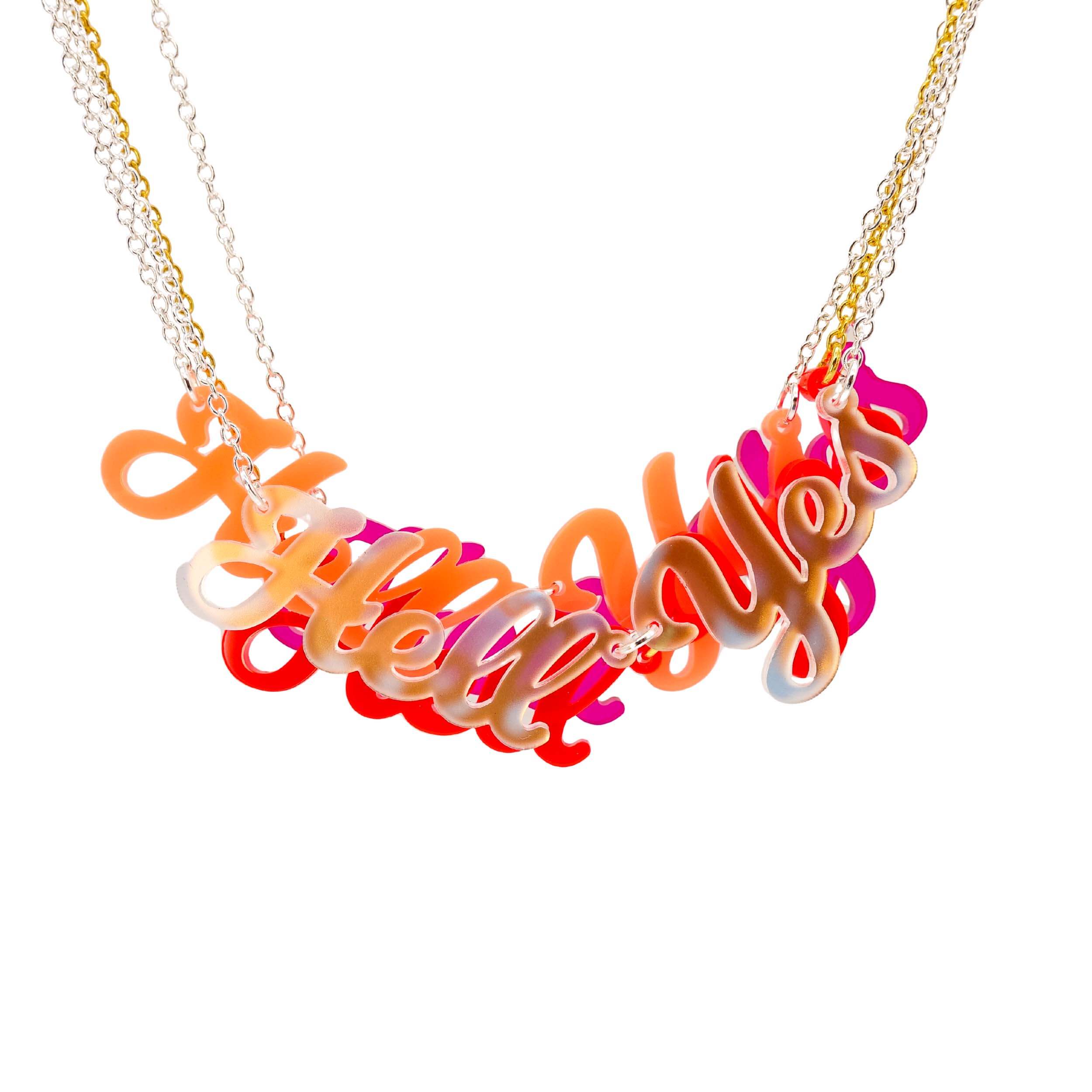 A group of Hell Yes necklaces hanging together, to show the combination of colours and the transparency of the iridescent material.