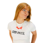 Eliza wears a Hell Yes necklace in hot red on a gold chain. Jewellery for partying in.