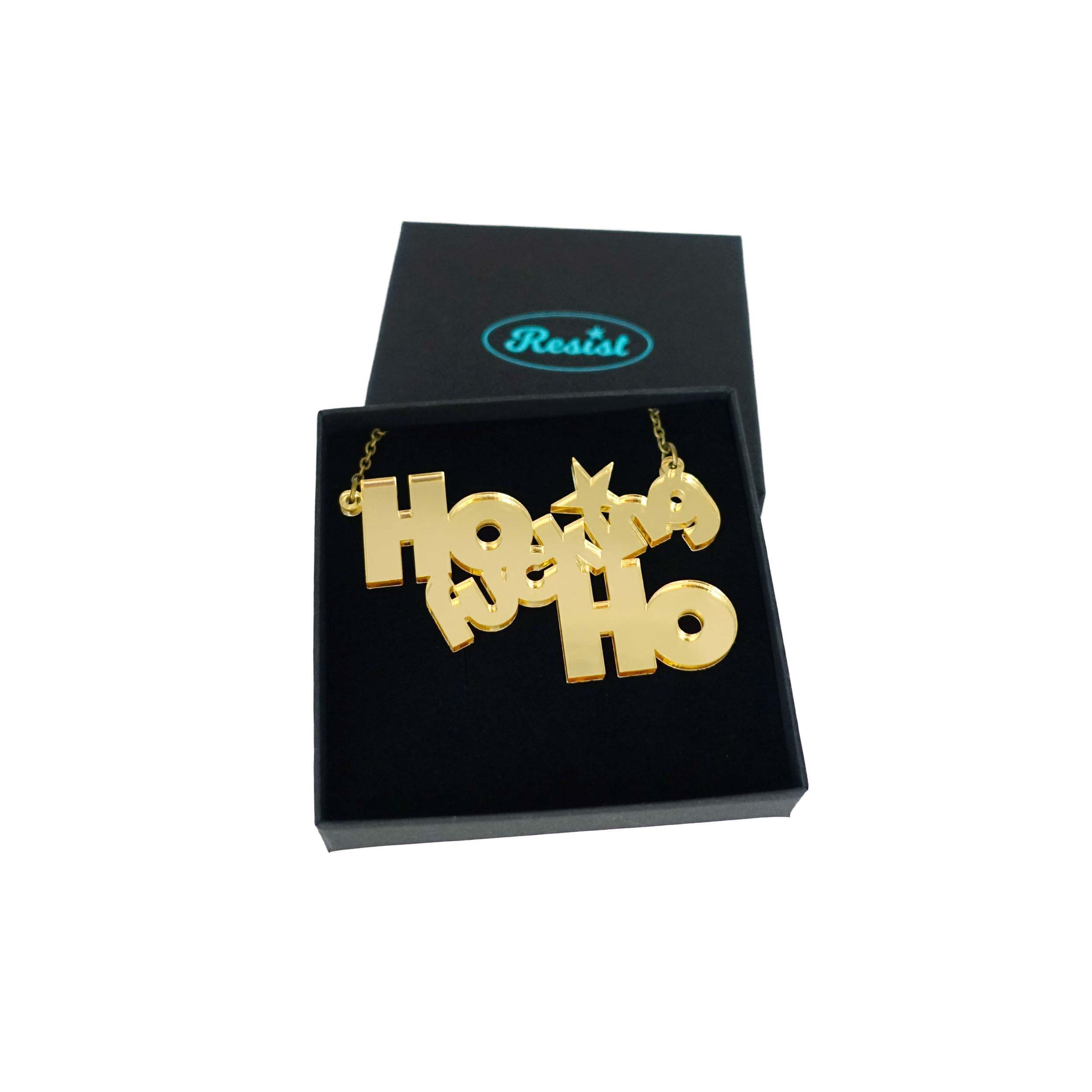 Ho F*cking Ho necklace in gold mirror, shown in a Wear and Resist gift box.