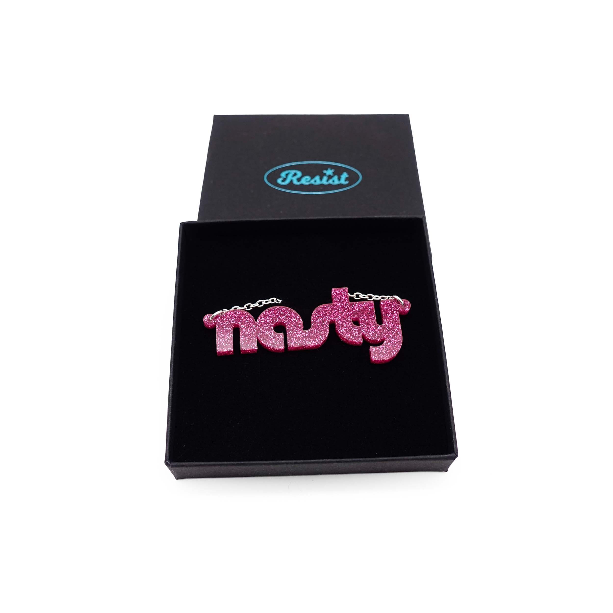 Nasty necklace in pink glitter, shown in a Wear and Resist gift box.