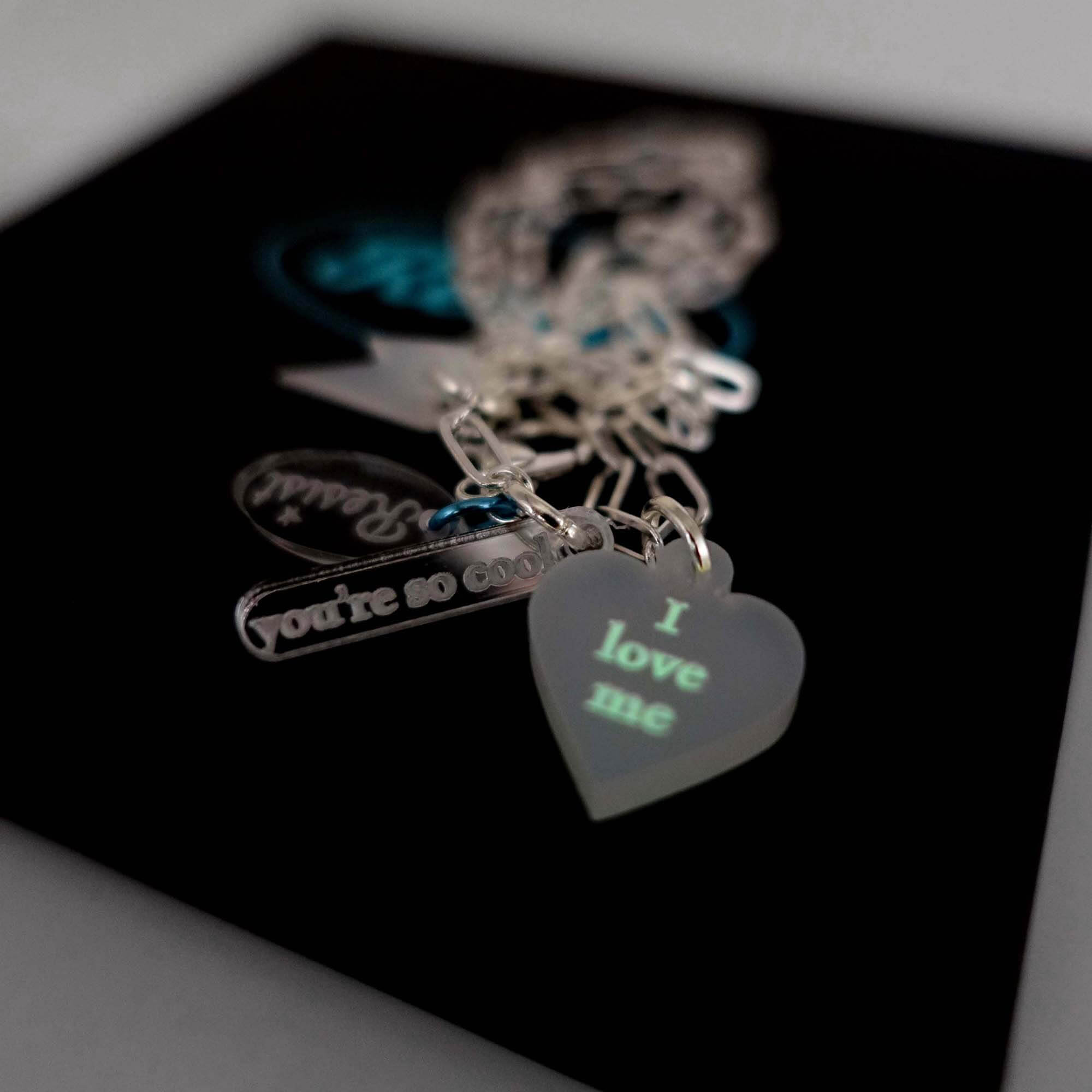 I love me glow in the dark choker and bracelet in secret white shown glowing with the 'You're so cool' tag. Show yourself some love!