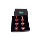 I Love Me heart drop earrings in red frost, shown in a Wear and Resist gift box.