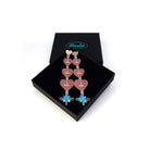 Blush pink I am I am I am heart drop earrings shown in a Wear and Resist gift box.