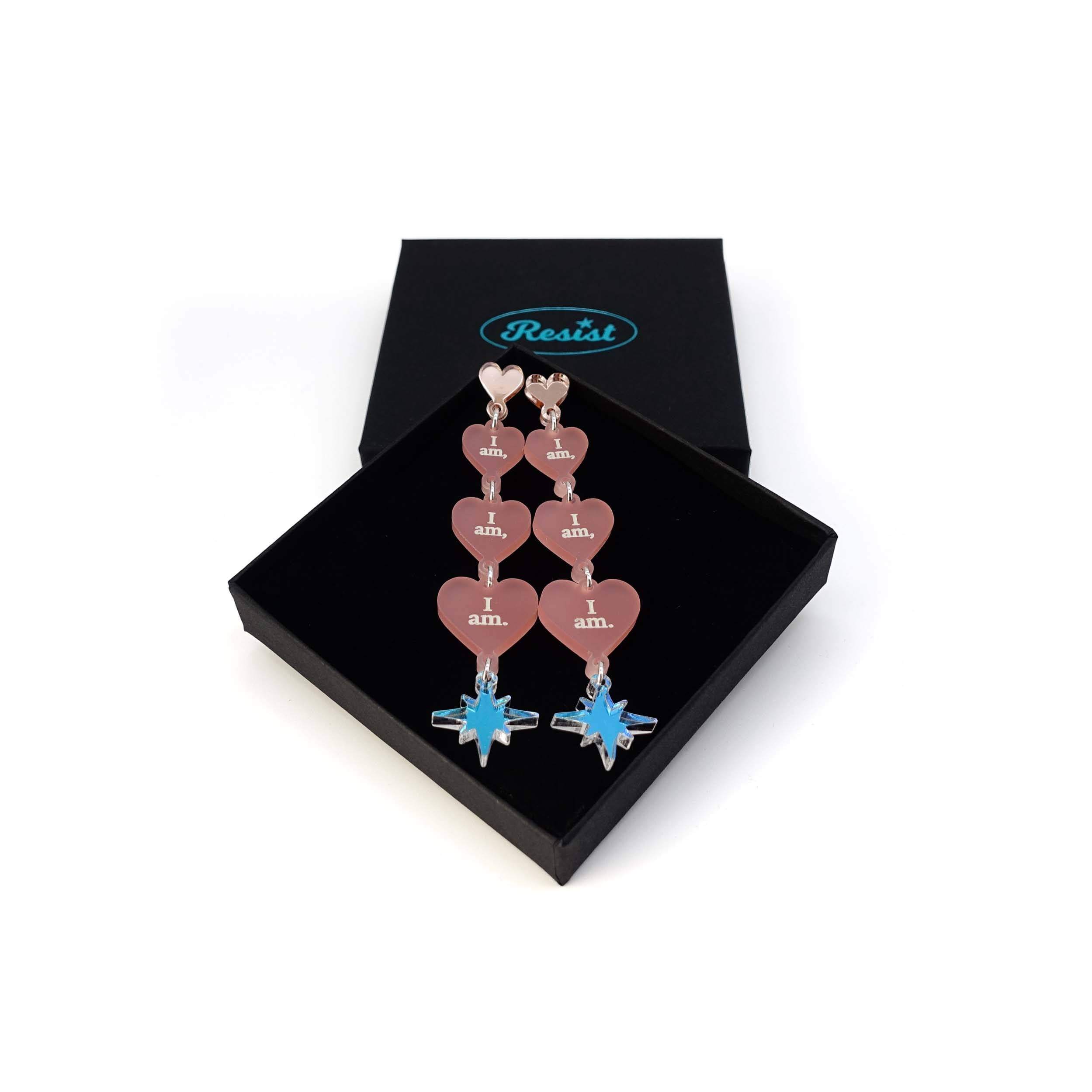 Blush pink I am I am I am heart drop earrings shown in a Wear and Resist gift box.