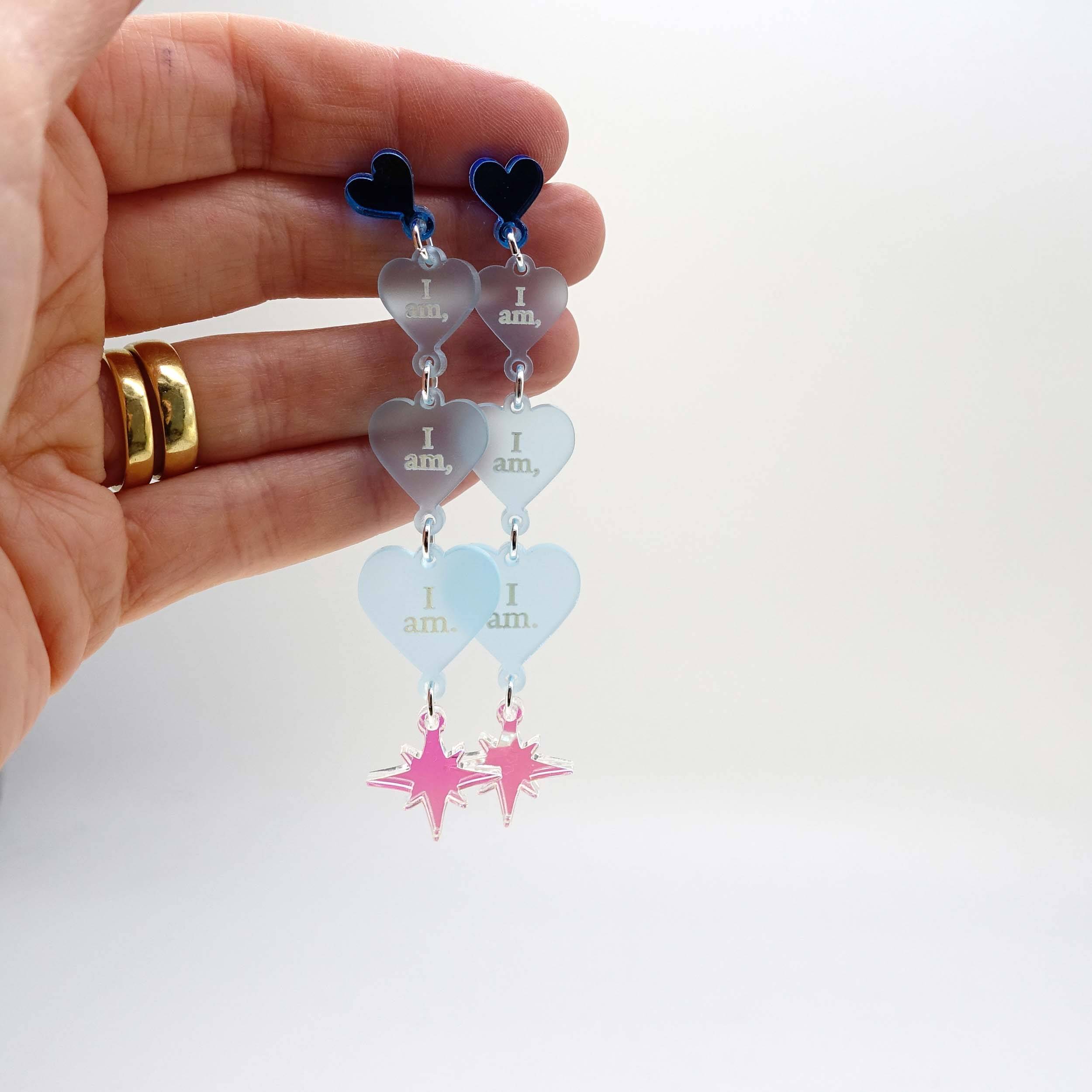 Sea foam  I am I am I am heart drop earrings shown held up for scale.