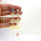Lemonade frost  I am I am I am heart drop earrings shown held up for scale.
