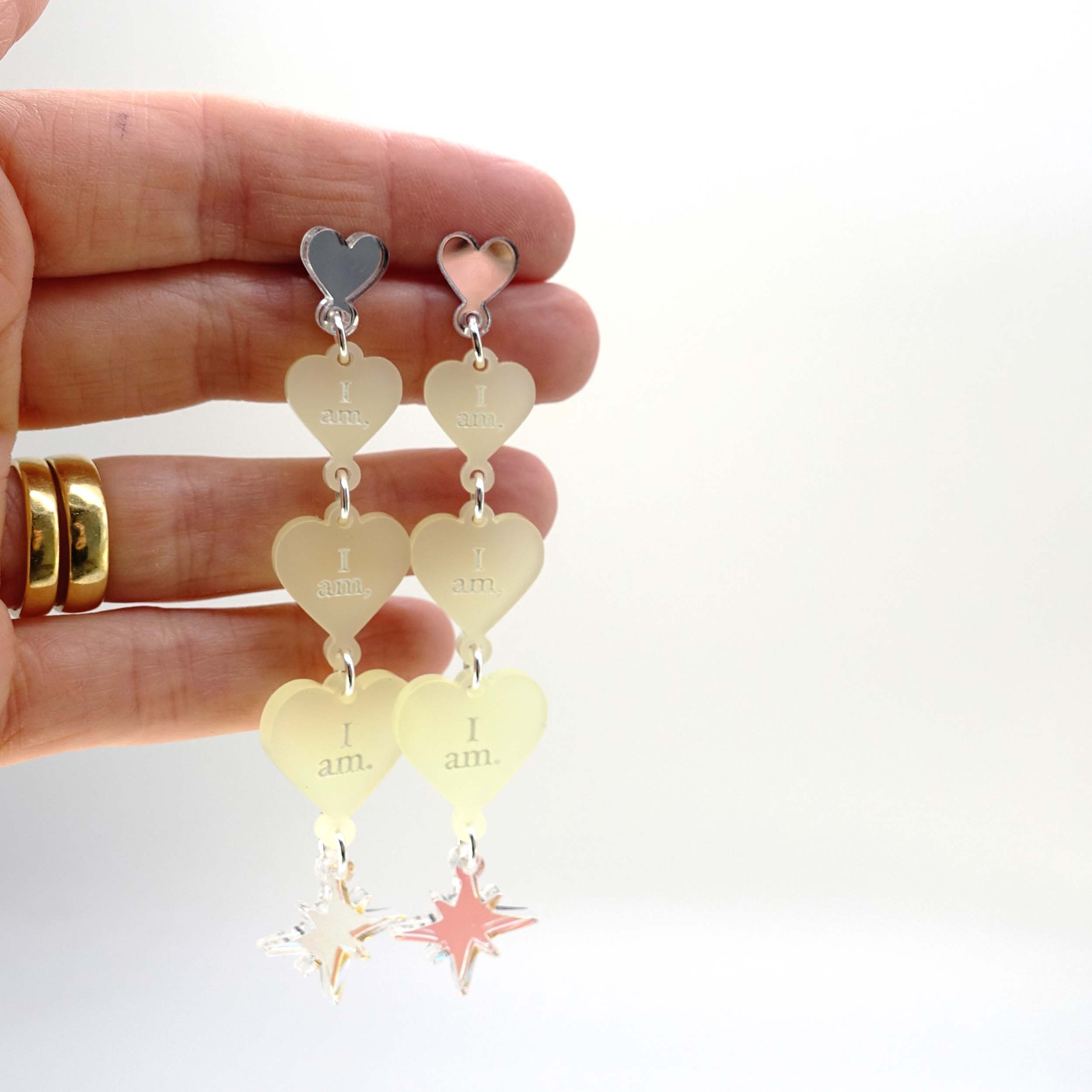 Lemonade frost  I am I am I am heart drop earrings shown held up for scale.