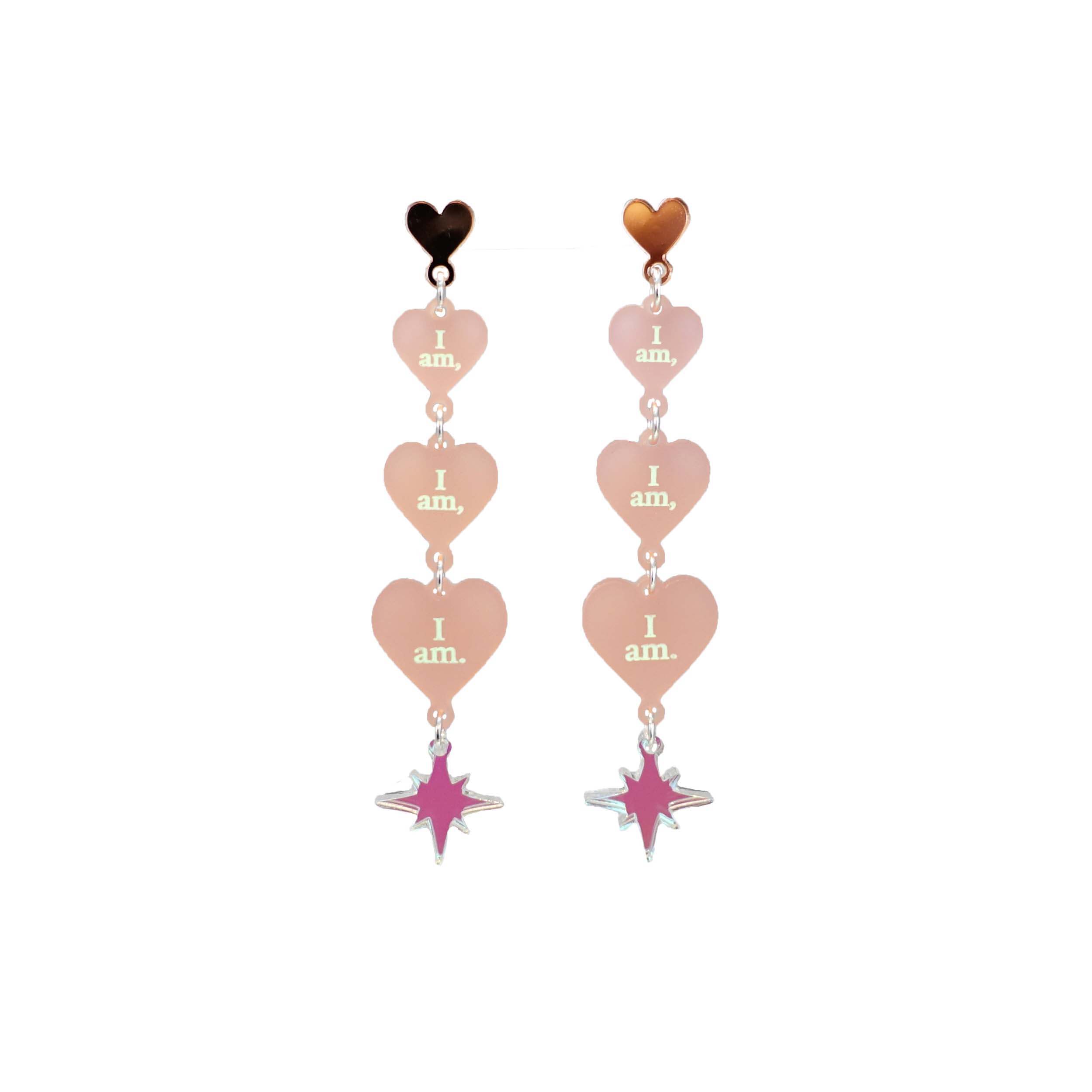 Blush pink  I am I am I am heart drop earrings finished with an iridescent star. The pigment glows in the dark.