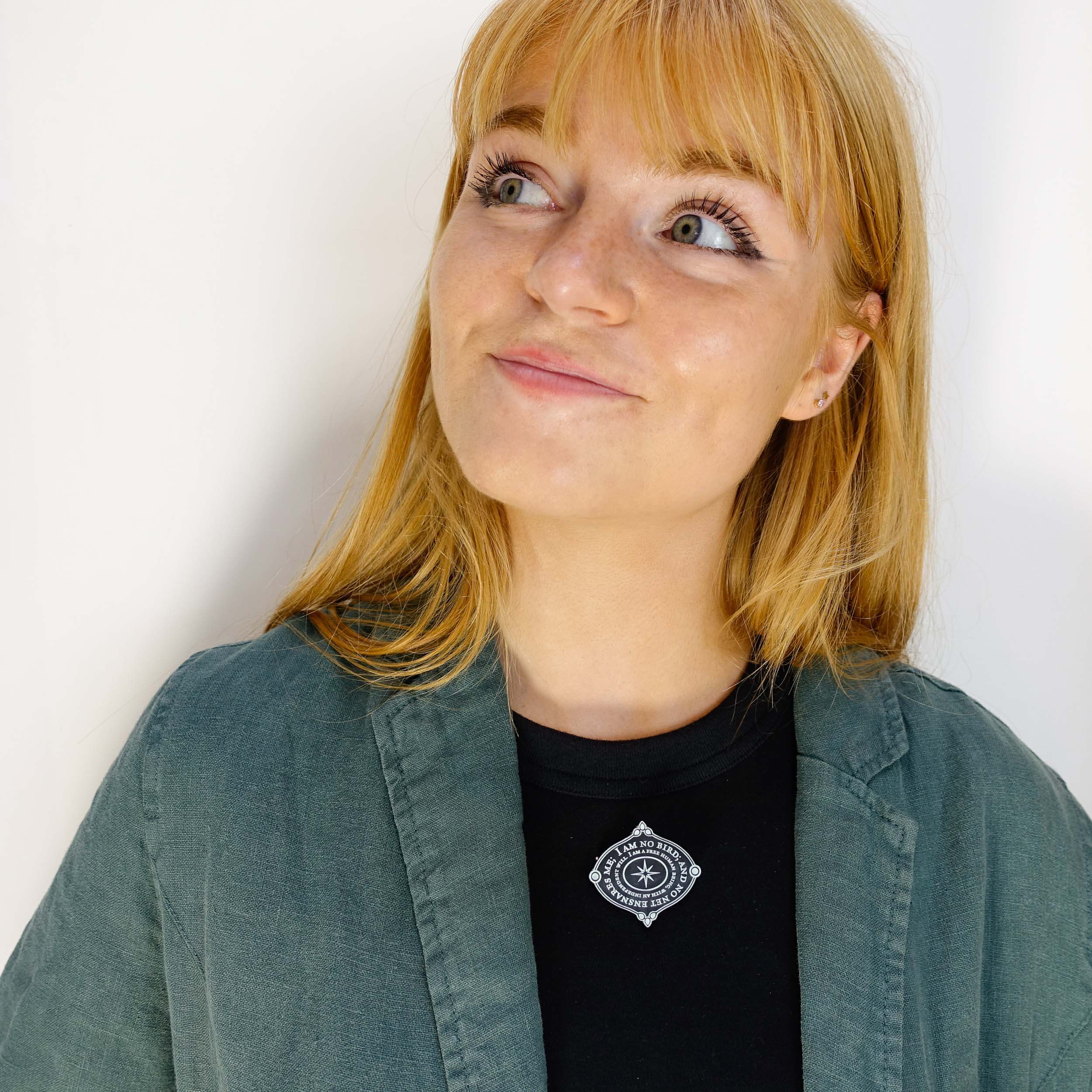 Eliza wears the 'I am no bird' Jane Eyre brooch from The Brontë Collection.