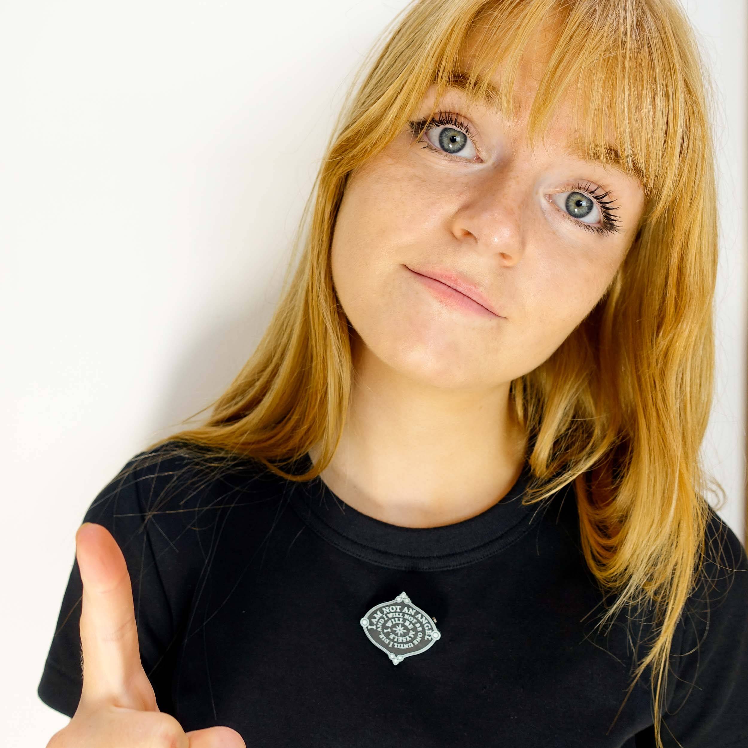 Eliza wears the I am not an Angel etched brooch from the Bronte collection.