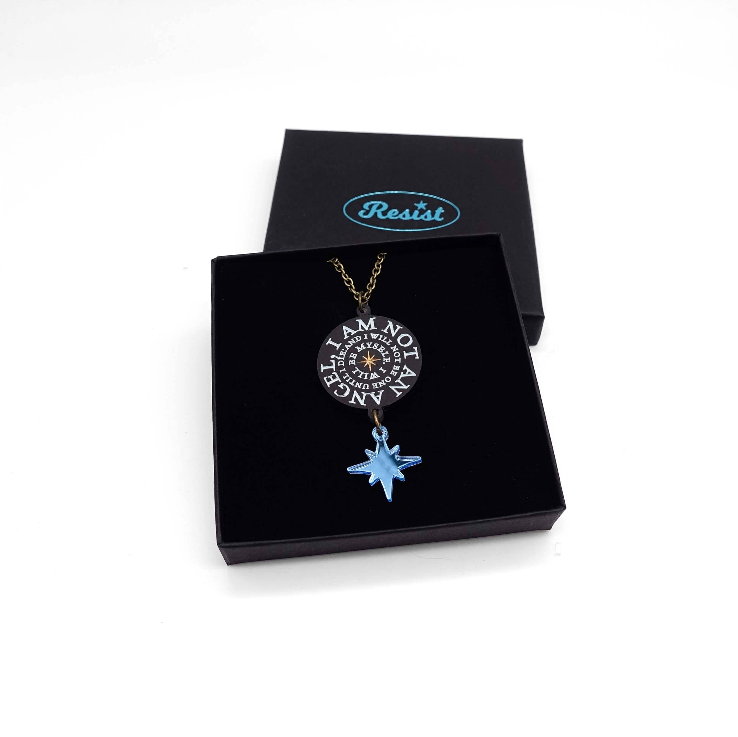 The 'I am not an angel' pendant etched with the famous words of Jane Eyre and finished with a blue star. Designed by Sarah Day of Wear and Resist in collaboration with the Brontë Parsonage Museum.