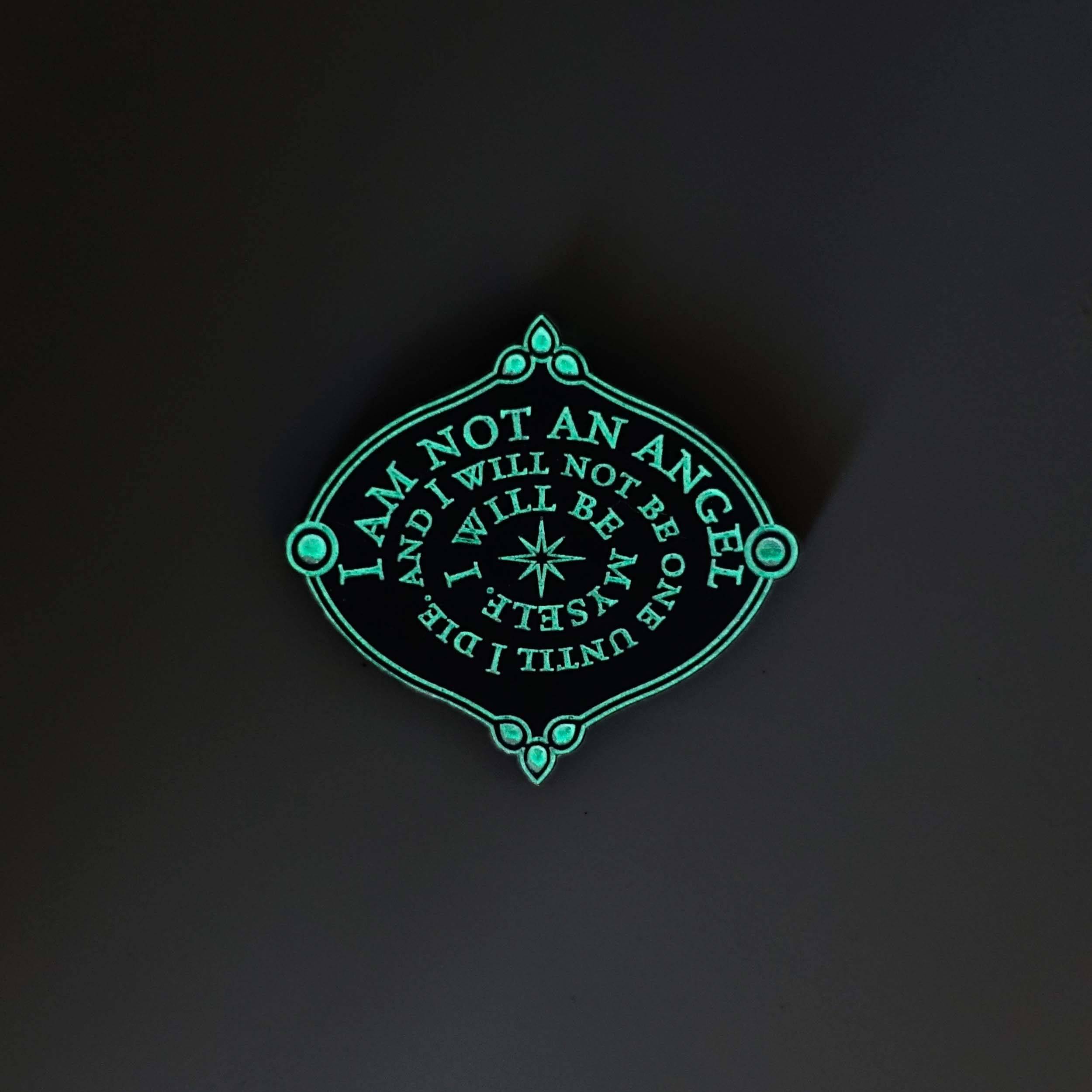 I am not an angel etched brooch glowing in the dark.