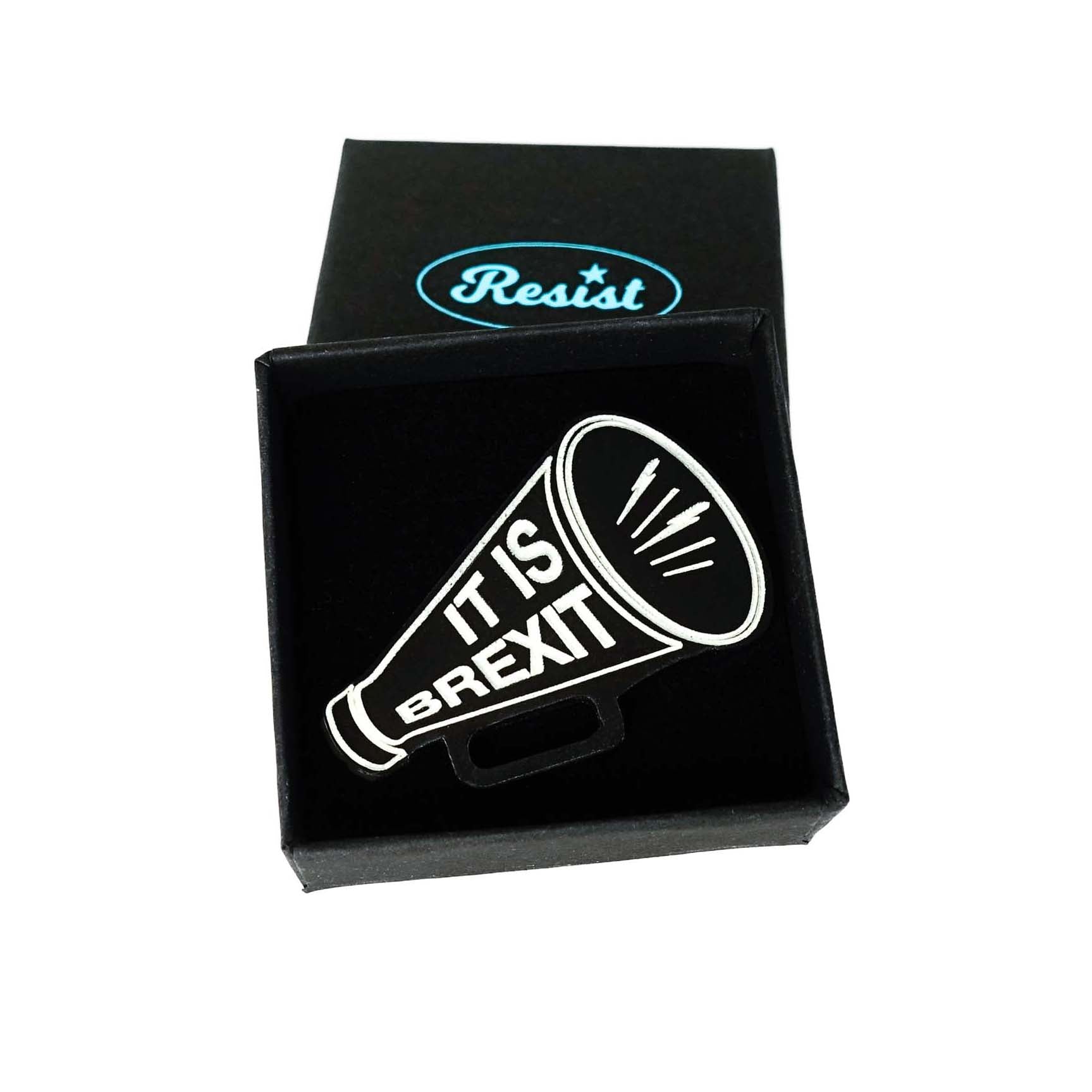 Megaphone brooch etched with 'It is Brexit' in glow-in-the-dark pigment. Shown in a small Wear and Resist gift box.