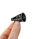 Megaphone brooch etched with 'It is Brexit' in glow-in-the-dark pigment. Shown held up in my fingers for size reference.