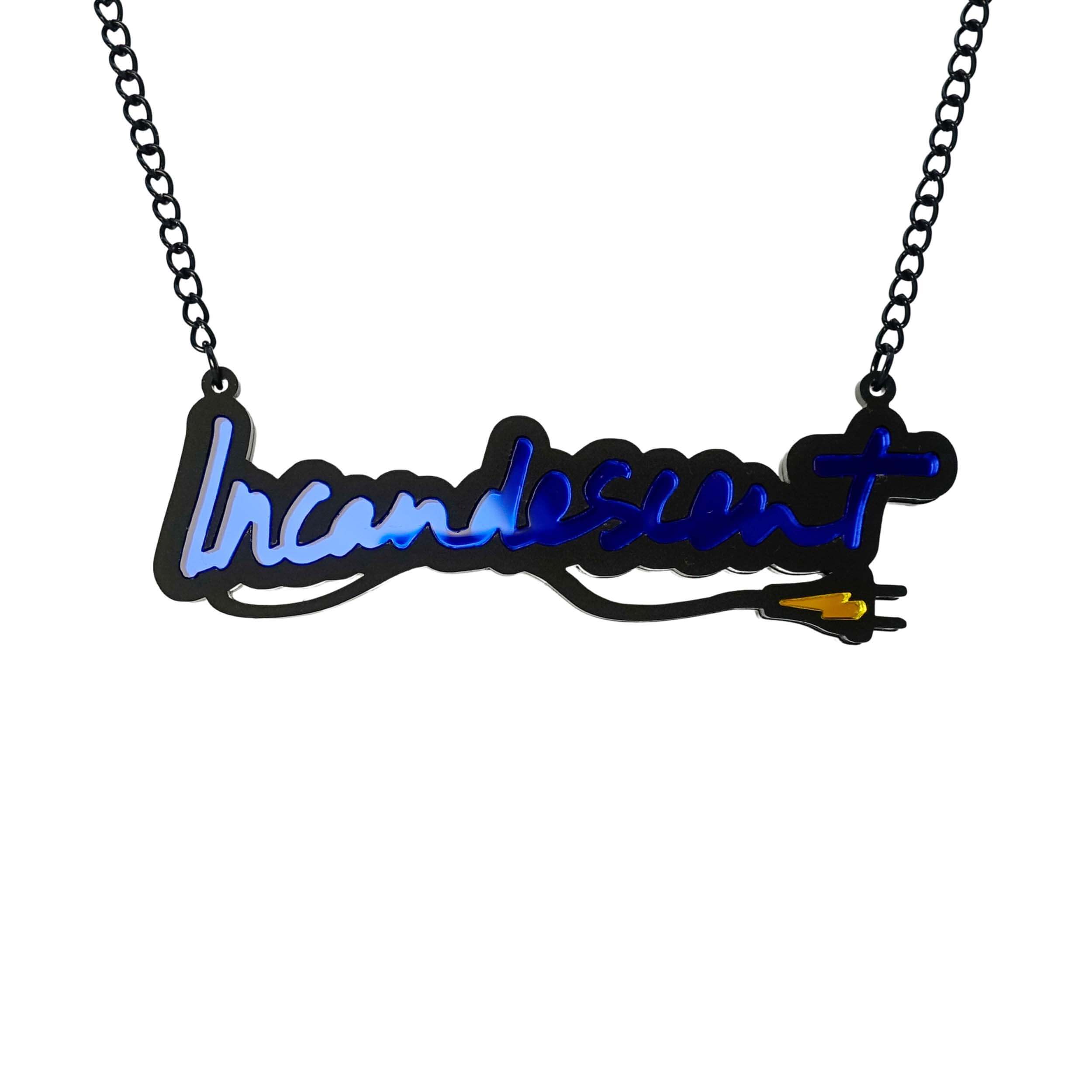 Incandescent neon necklace in electric blue with a yellow lightning bolt plug, on a black chain adjustable to three lengths. Shown hanging against a white backround.