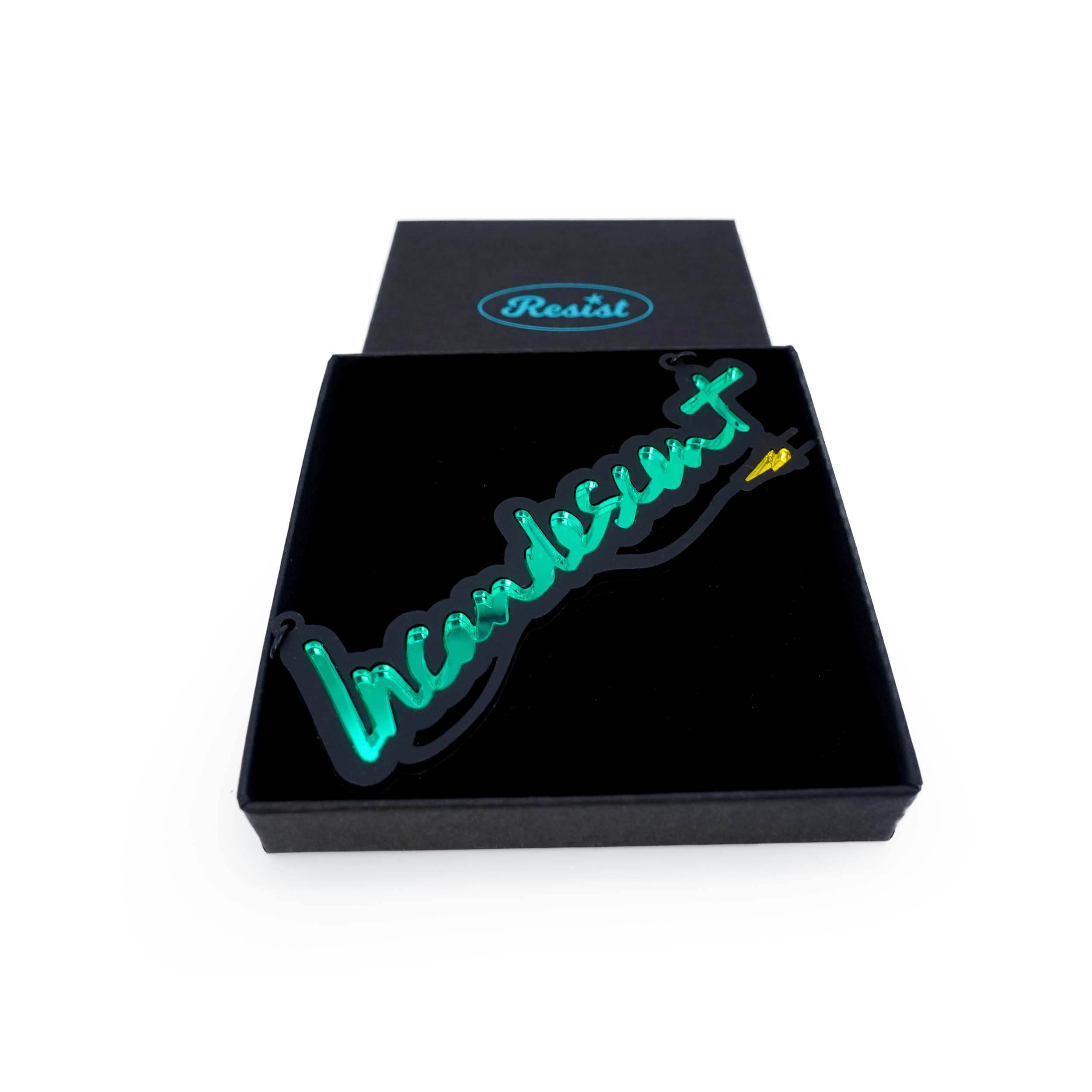 An Incandescent neon necklace in electric green shown in a Wear and Resist gift box.