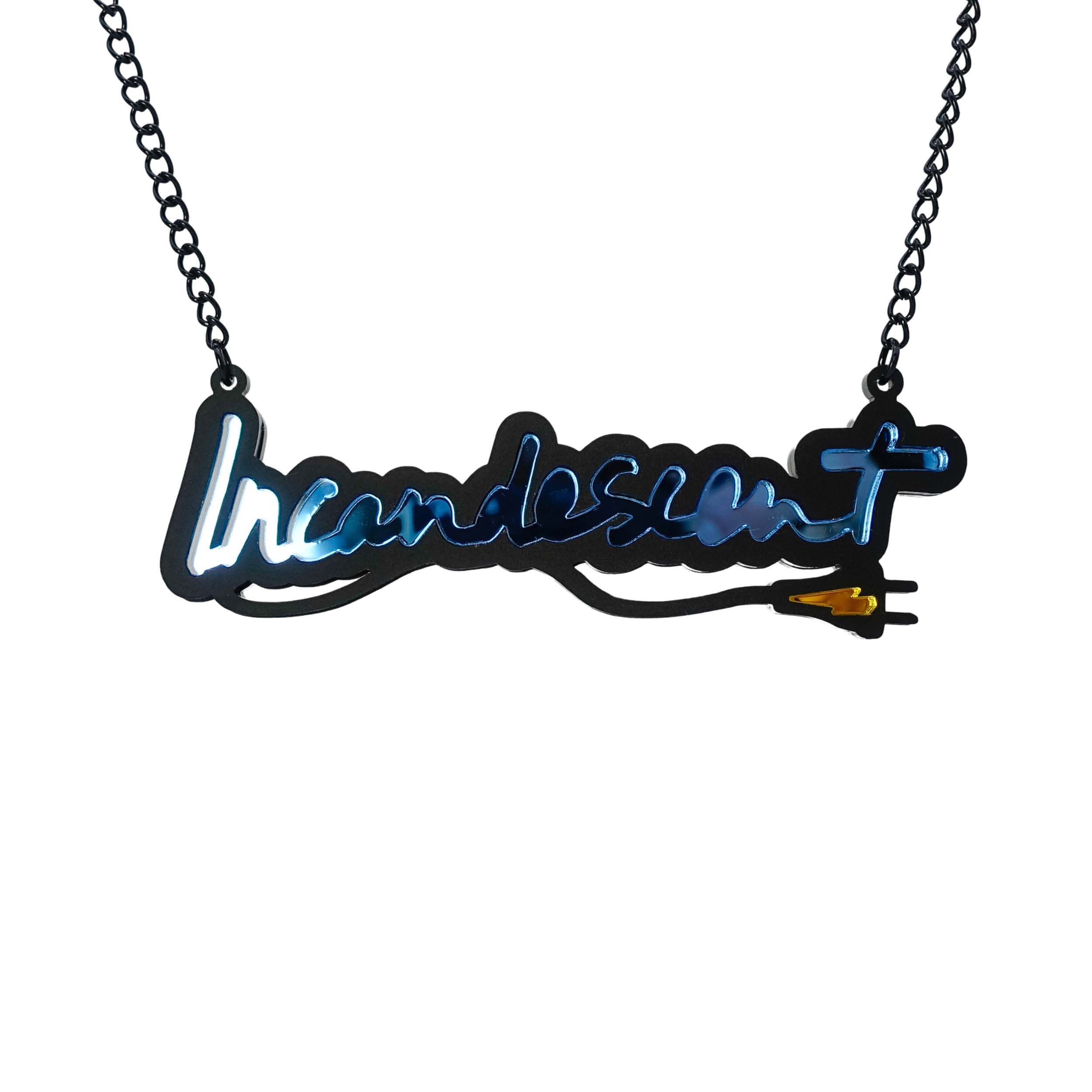 An Incandescent neon necklace in sky blue shown hanging on a black chain adjustable to three lengths.