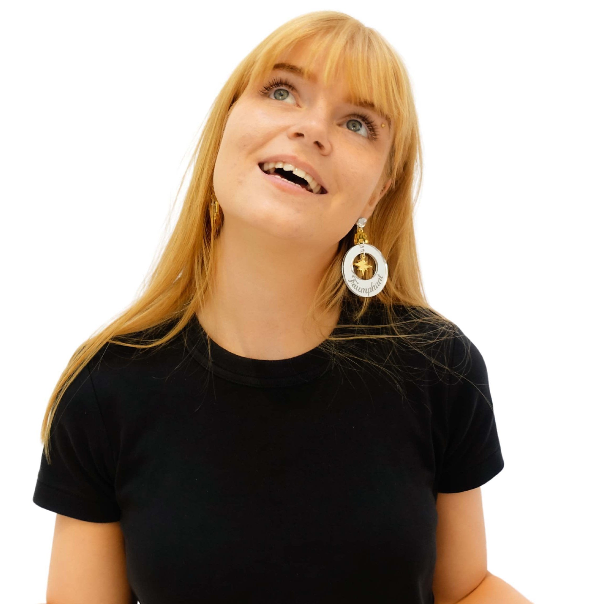 Eliza wears Joyful and Triumphant Christmas Bauble earrings in gold and silver.