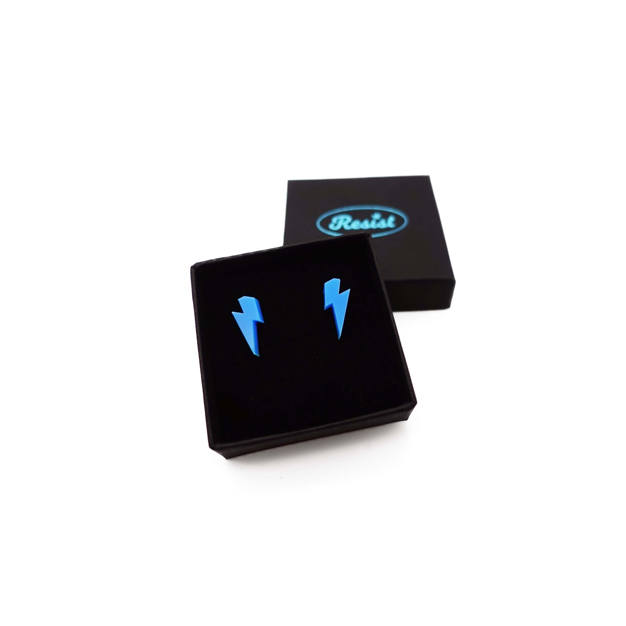 Tiny Lightning Bolt earrings in Matisse blue, shown in a small Wear and Resist gift box.
