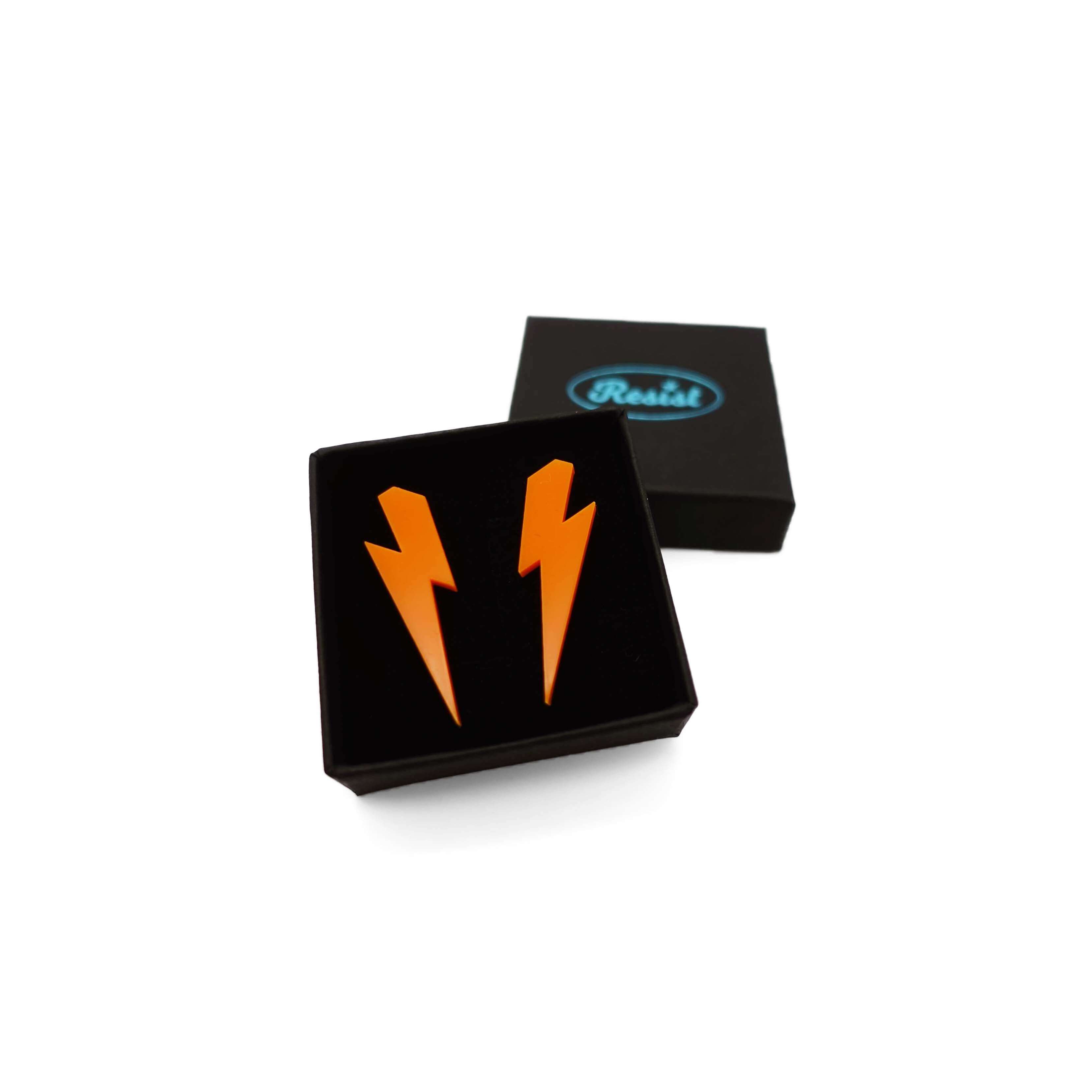 Medium Lightning Bolt earrings in orange, shown in a small Wear and Resist gift box.