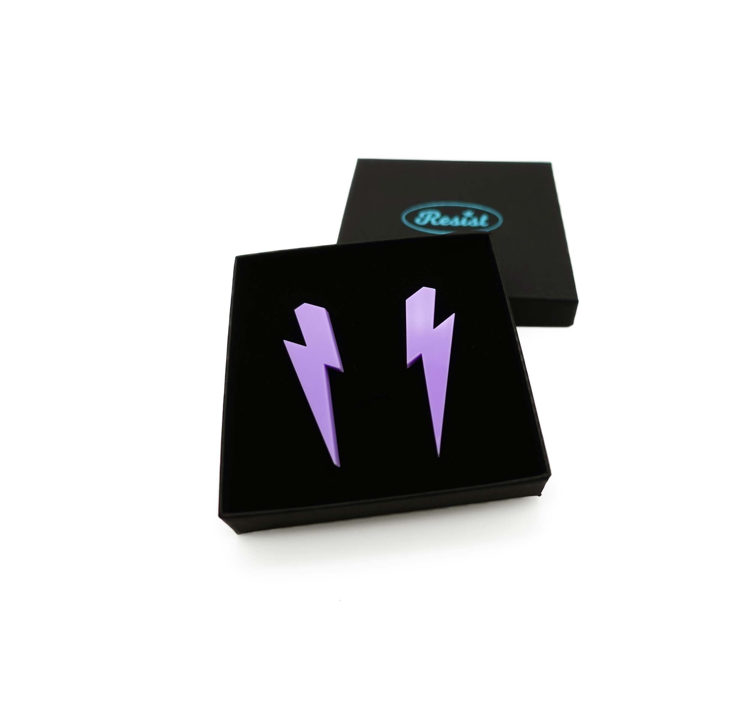 Large Lightning Bolt earrings in parma violet, shown in a Wear and Resist gift box.