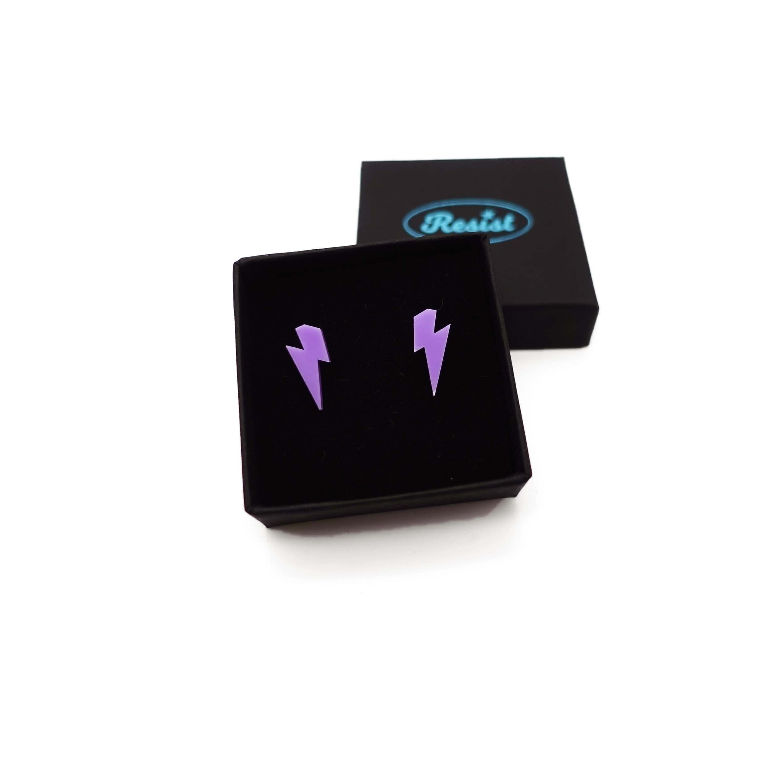Tiny Lightning Bolt earrings in parma violet, shown in a small Wear and Resist gift box.