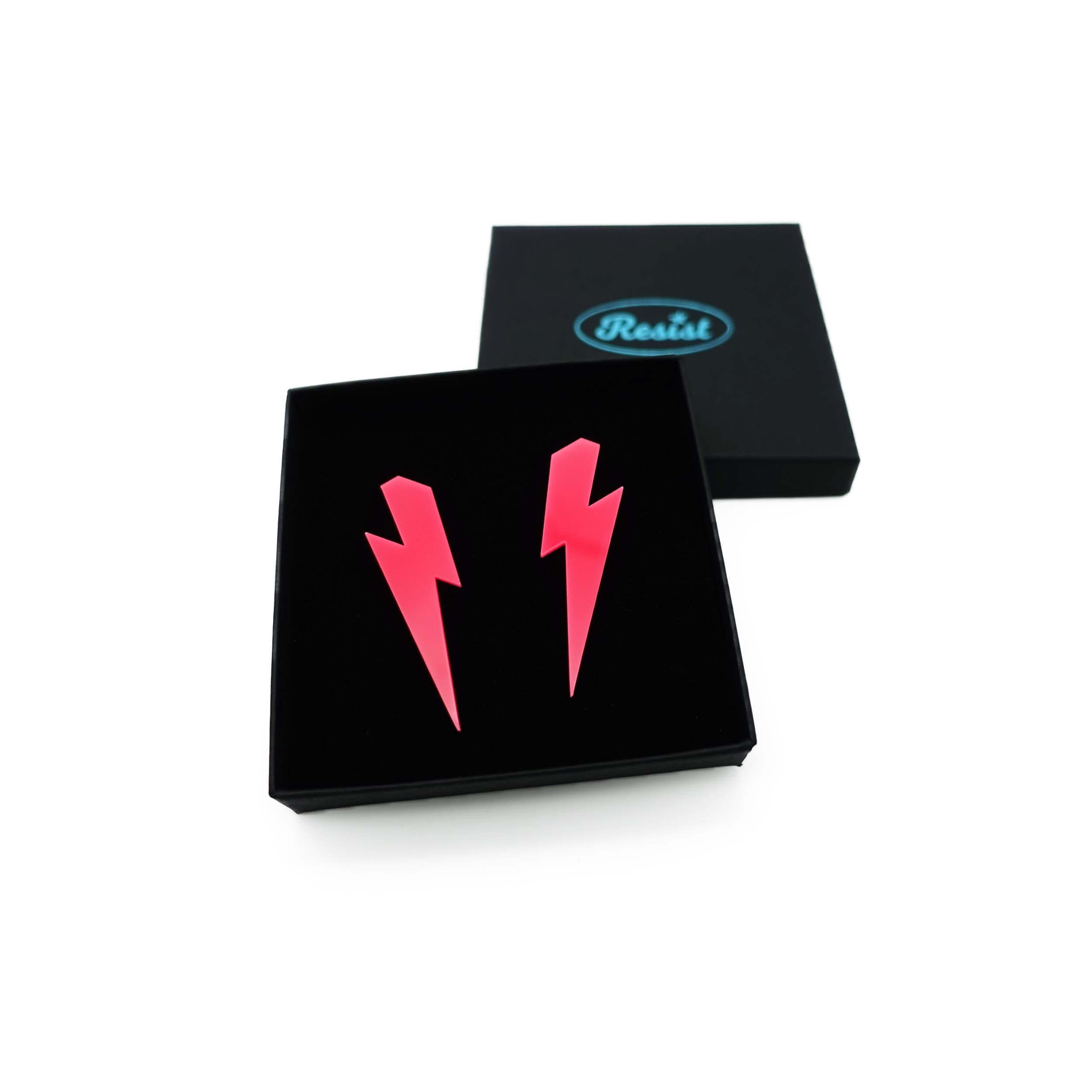 Large Lightning Bolt earrings in hot pink, shown in a Wear and Resist gift box.