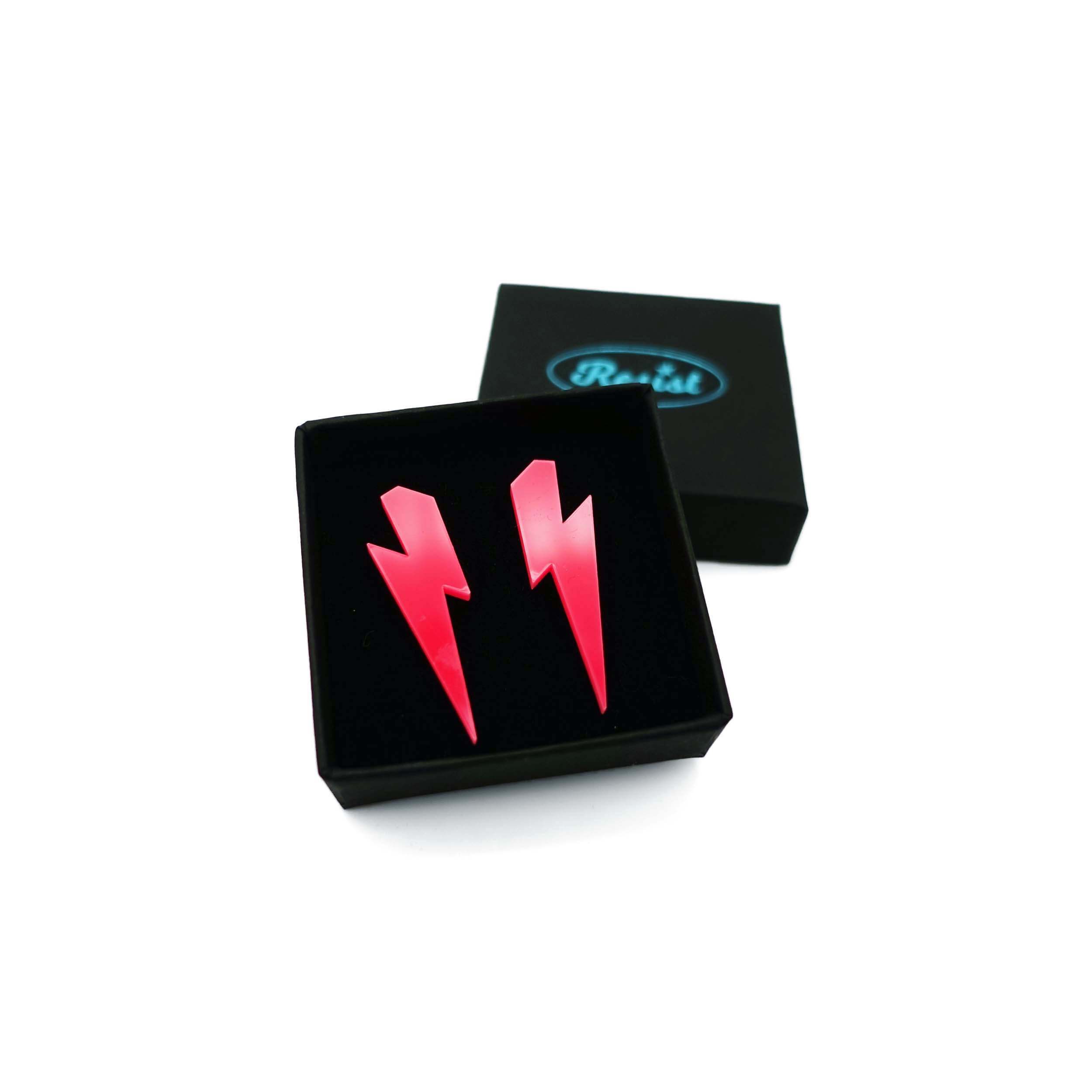Medium Lightning Bolt earrings in hot pink, shown in a small Wear and Resist gift box.