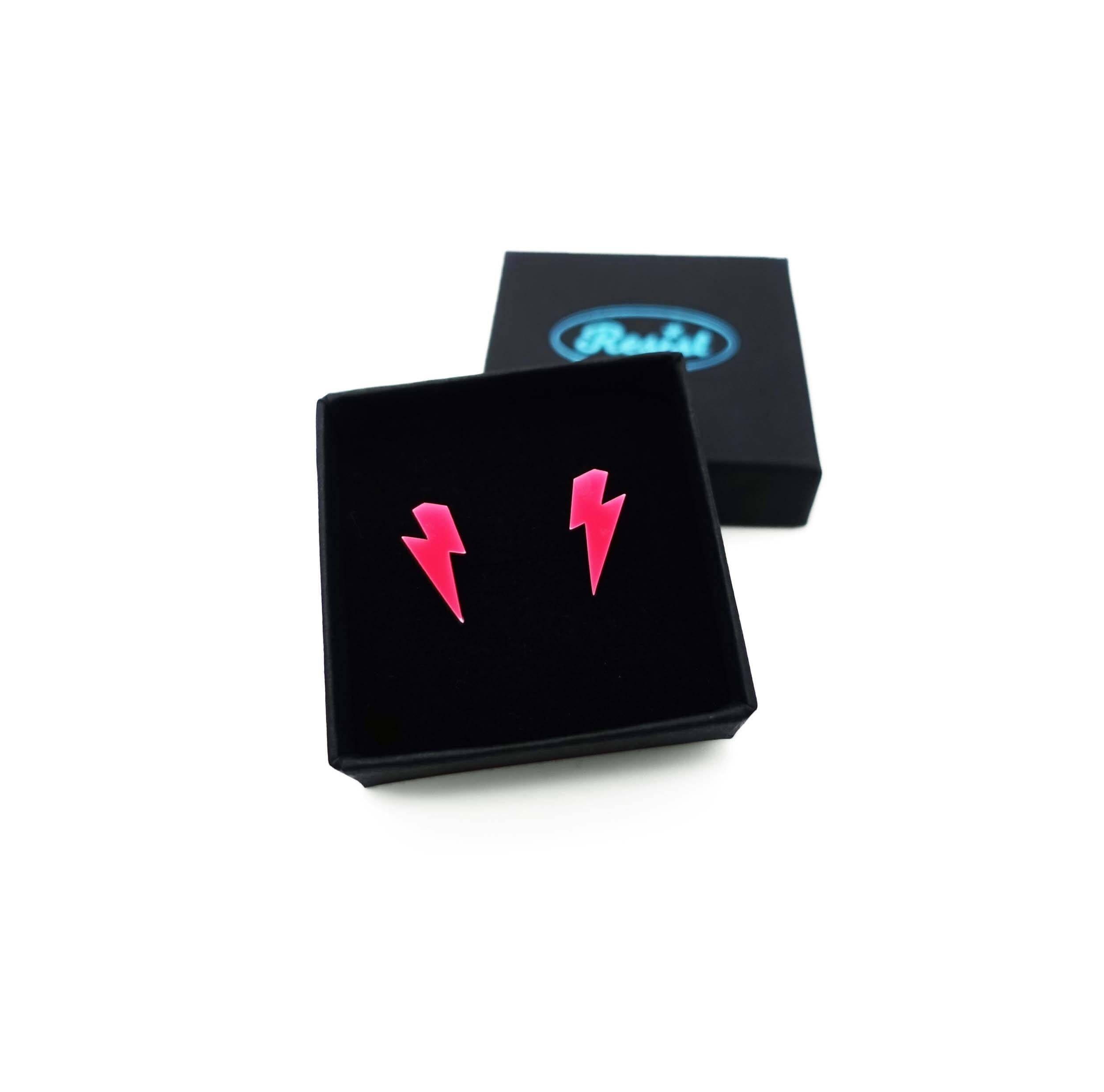 Tiny Lightning Bolt earrings in hot pink, shown in a small Wear and Resist gift box.