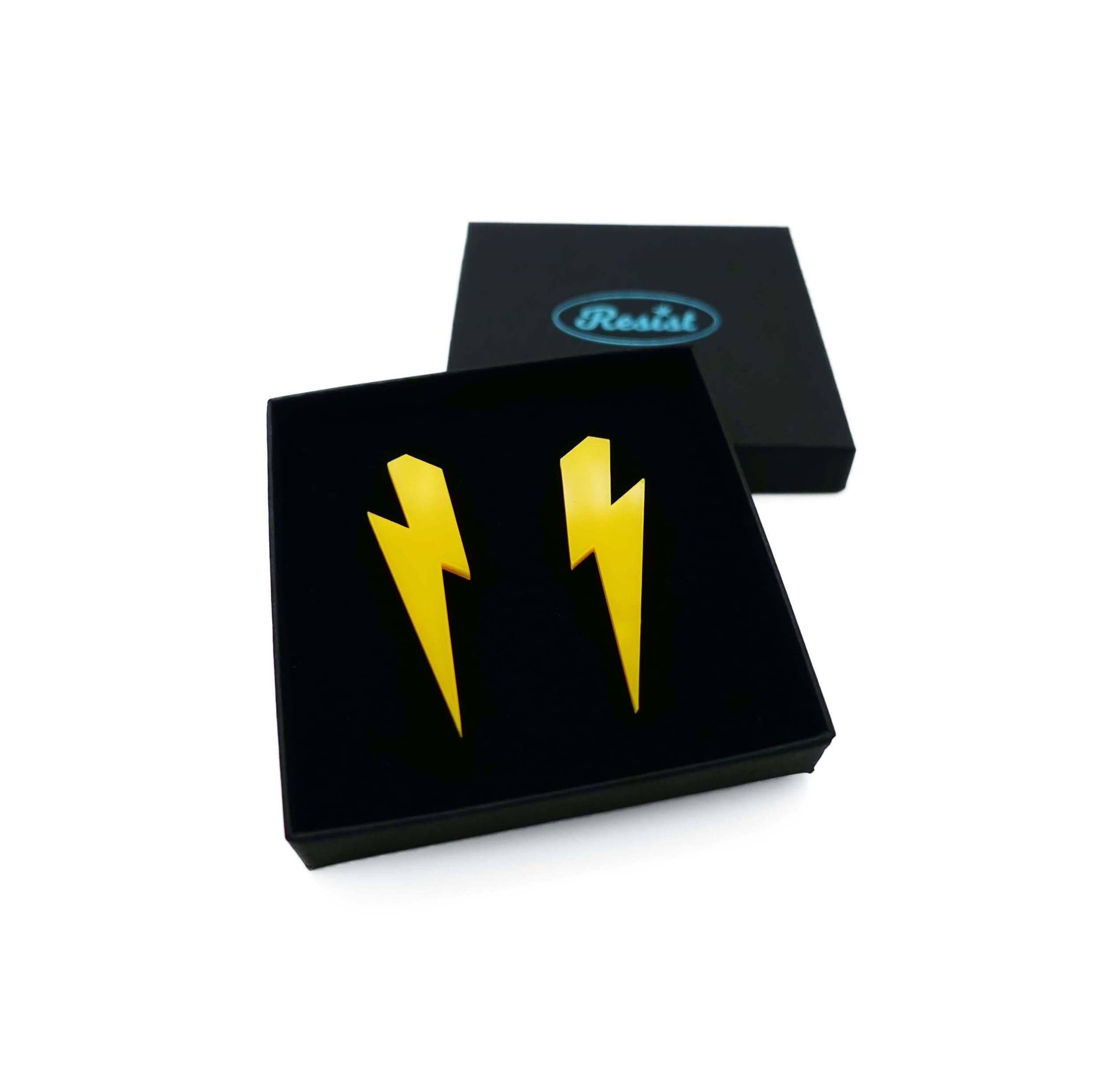 Large Lightning Bolt earrings in sunflower yellow, shown in a Wear and Resist gift box.