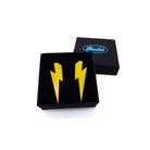Medium Lightning Bolt earrings in sunflower yellow, shown in a small Wear and Resist gift box.