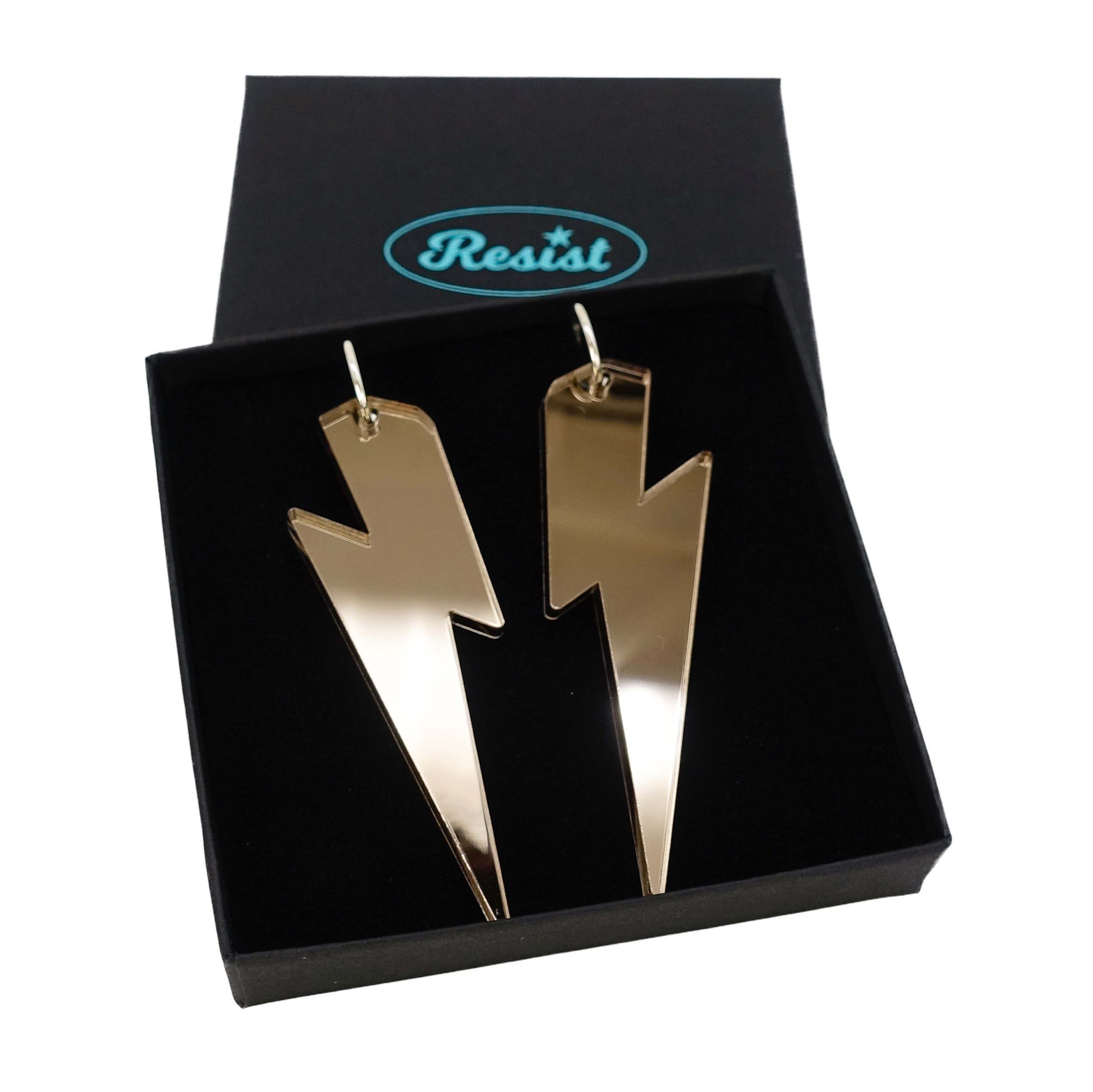 Massive Lightning Bolt hoop earrings in bronze mirror, shown in a Wear and Resist gift box.