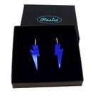Electric blue mirror medium Lightning Bolt earrings on silver hoops, shown in a Wear and Resist gift box.