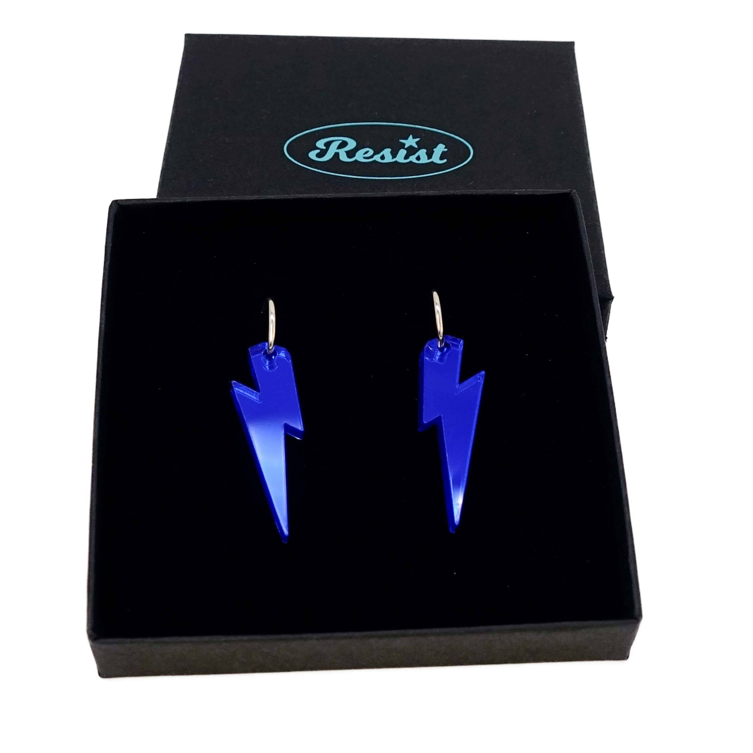 Electric blue mirror medium Lightning Bolt earrings on silver hoops, shown in a Wear and Resist gift box.