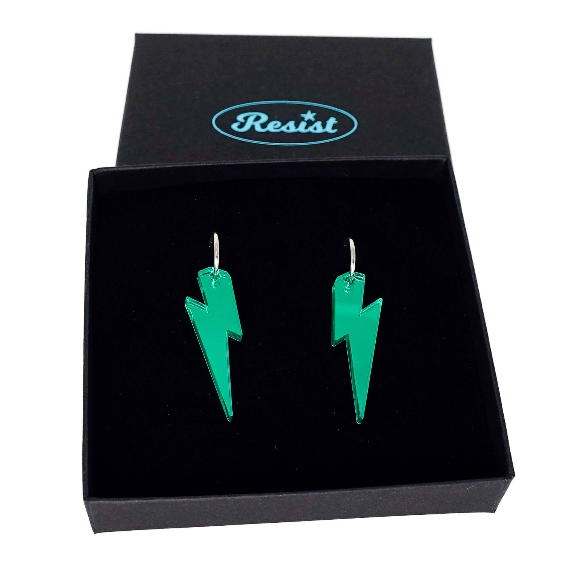 Electric green mirror medium Lightning Bolt earrings on silver hoops, shown in a Wear and Resist gift box.
