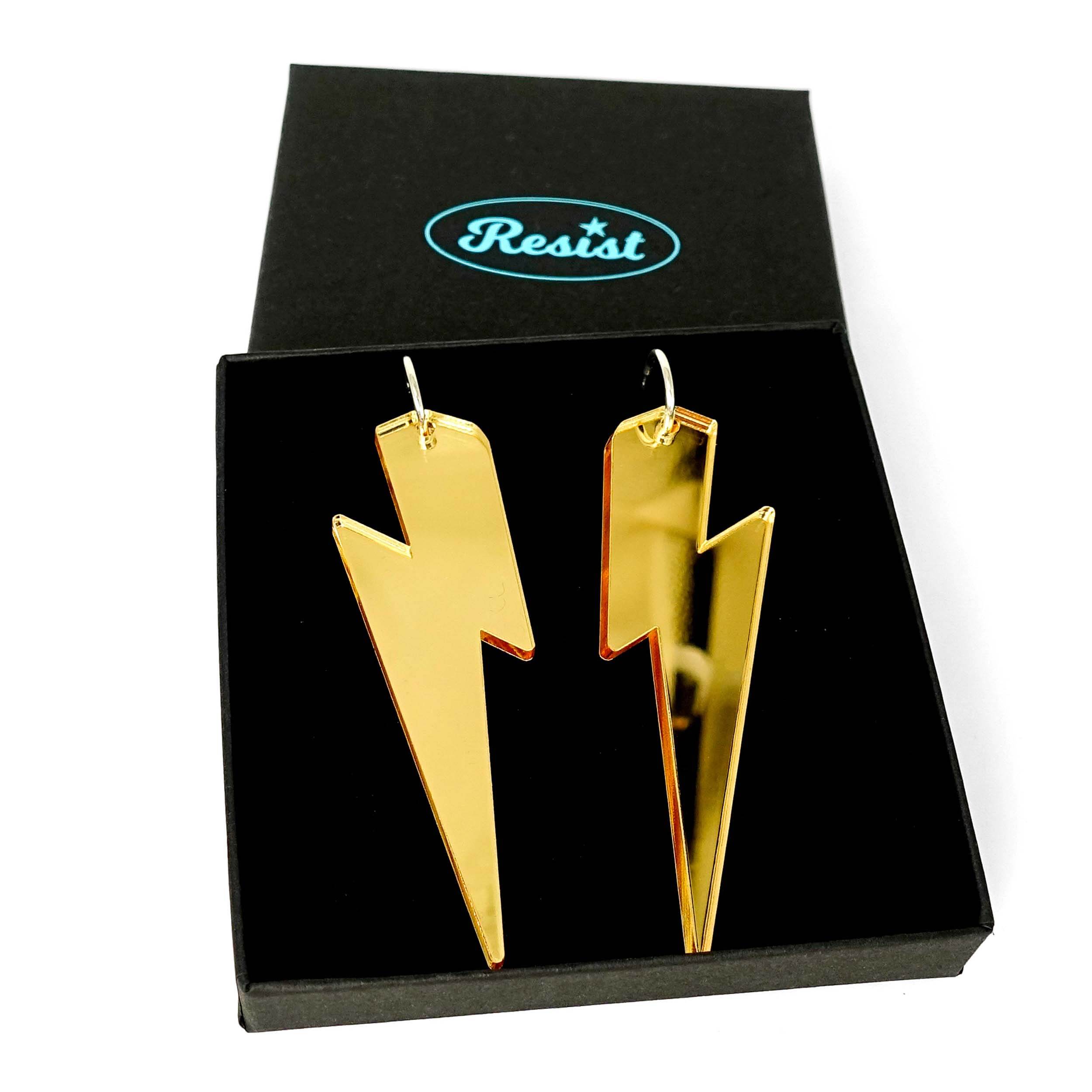 Massive Lightning Bolt hoop earrings in gold mirror, shown in a Wear and Resist gift box.