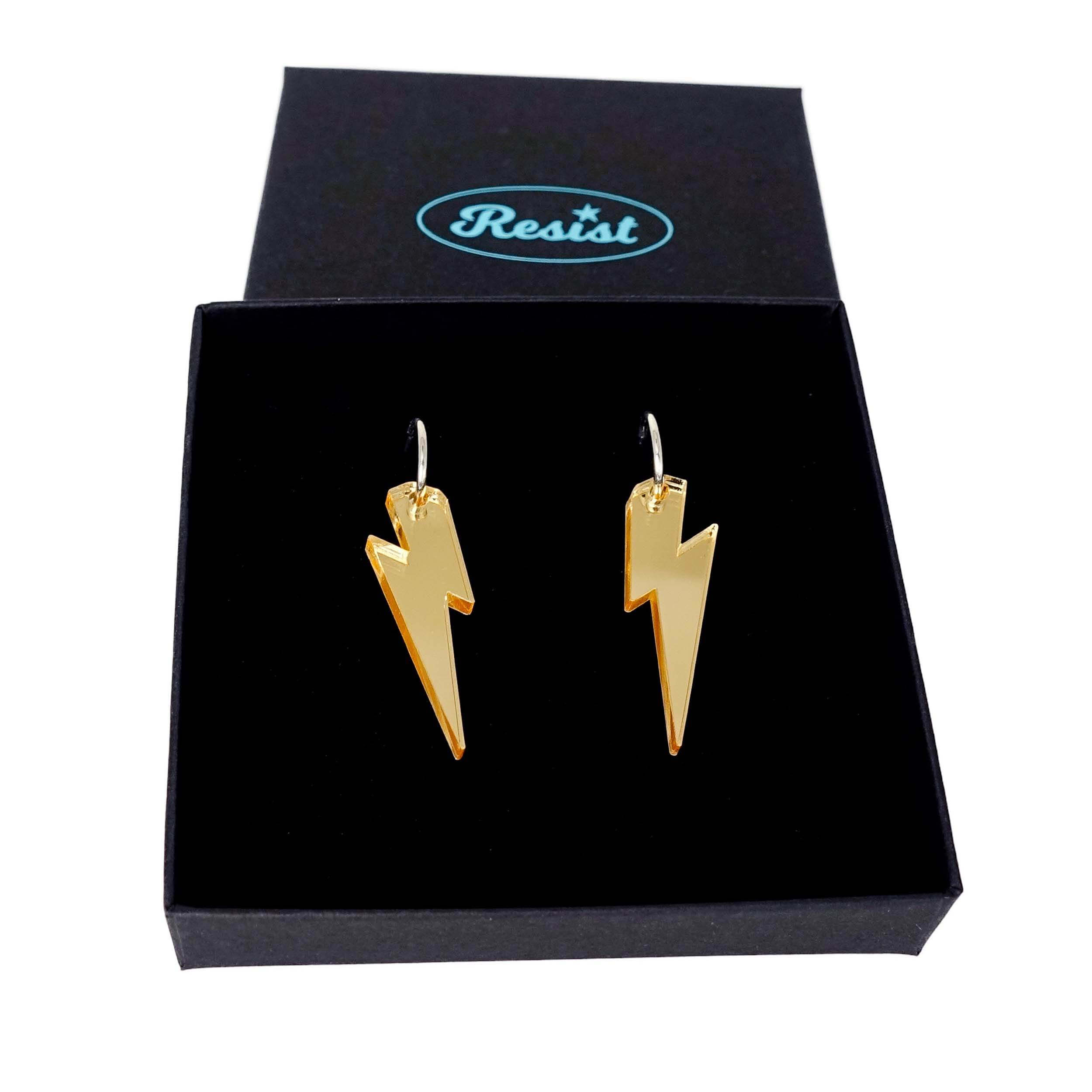 Gold mirror medium Lightning Bolt earrings on silver hoops, shown in a Wear and Resist gift box.