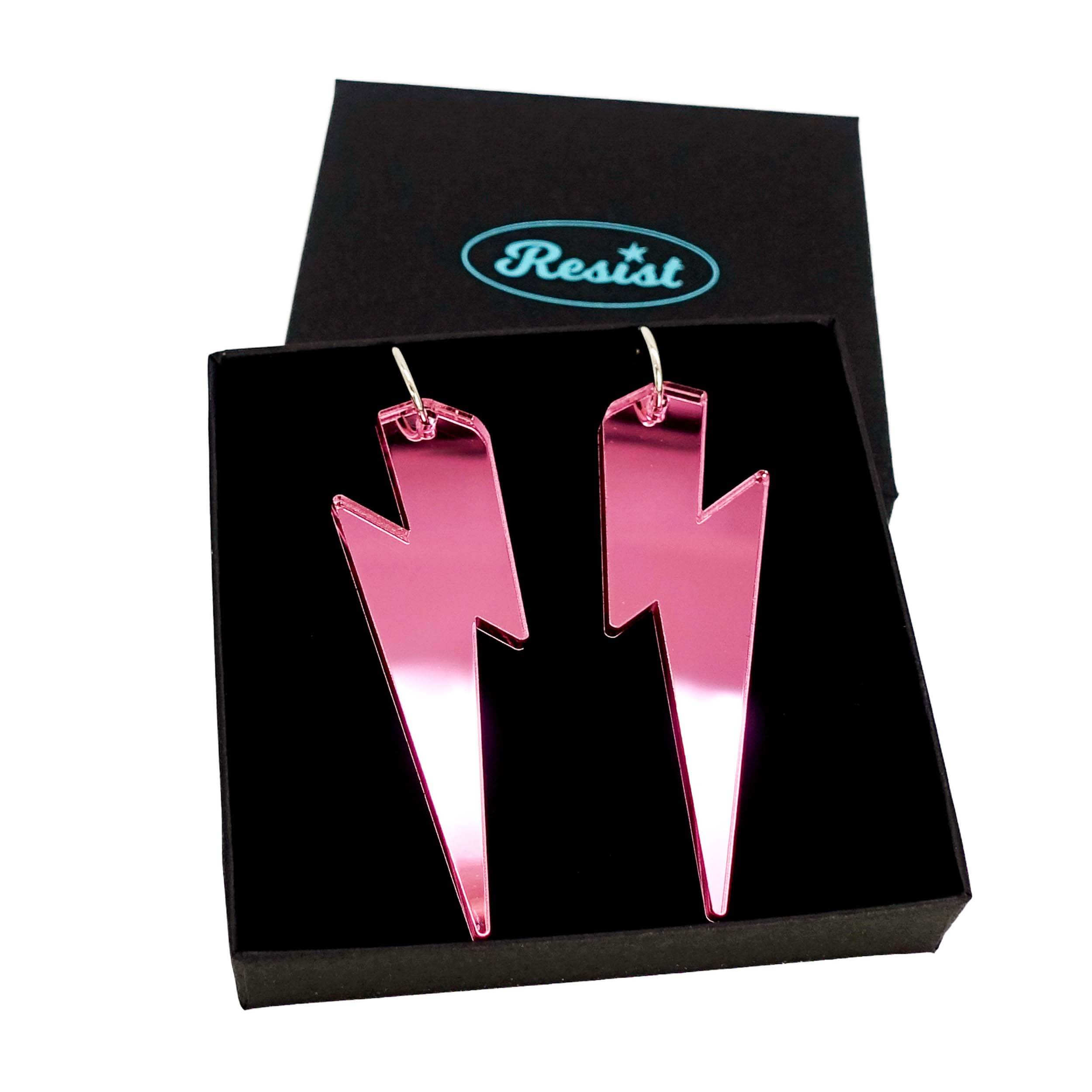 Massive Lightning Bolt hoop earrings in pink mirror, shown in a Wear and Resist gift box.