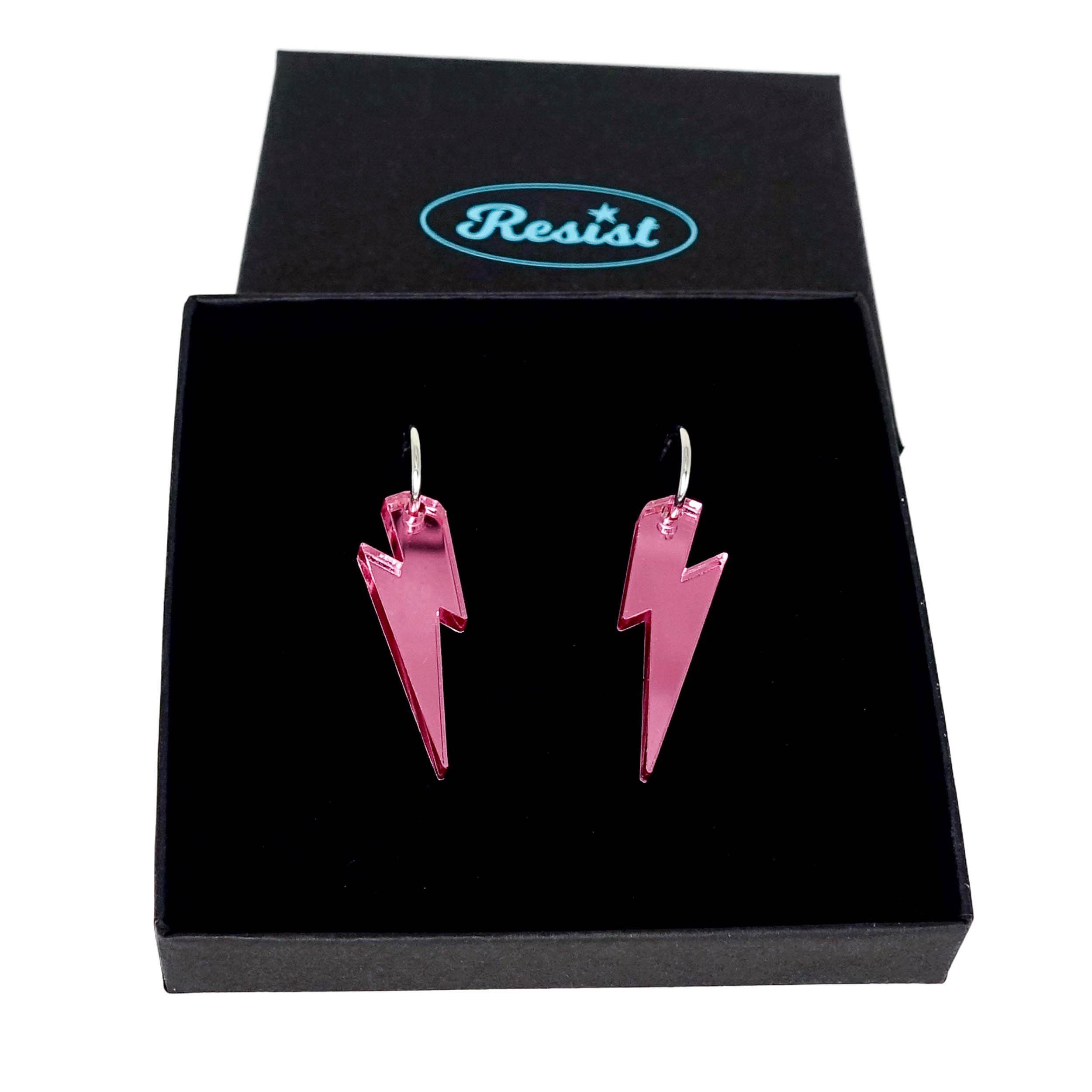 Pink mirror medium Lightning Bolt earrings on silver hoops, shown in a Wear and Resist gift box.