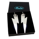 Massive Lightning Bolt hoop earrings in silver mirror, shown in a Wear and Resist gift box.