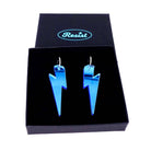 Large Lightning Bolt hoop earrings in sky mirror, shown in a Wear and Resist gift box.