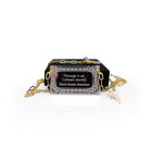 Literary Quote necklace etched with a quote by Zora Neale Hurston, 'Through it all, I am myself.' Shown on a gold plated paperclip chain in front of a small Wear and Resist gift box.