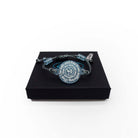 May I Be Safe bracelet in sea foam shown on a Wear and Resist gift box.