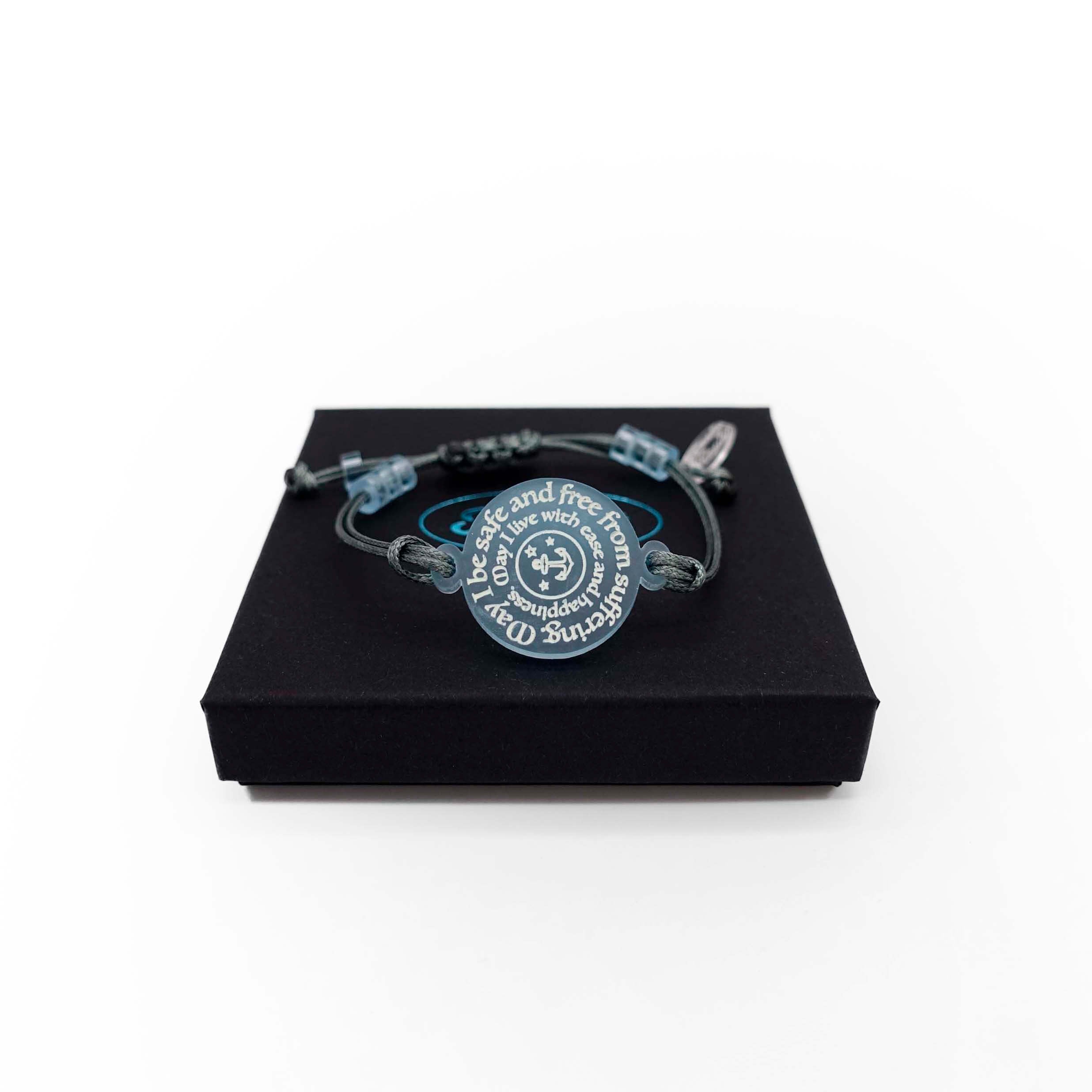 May I Be Safe bracelet in sea foam shown on a Wear and Resist gift box.