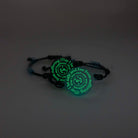 May I Be Safe bracelets in sea foam and shale shown glowing in the dark.