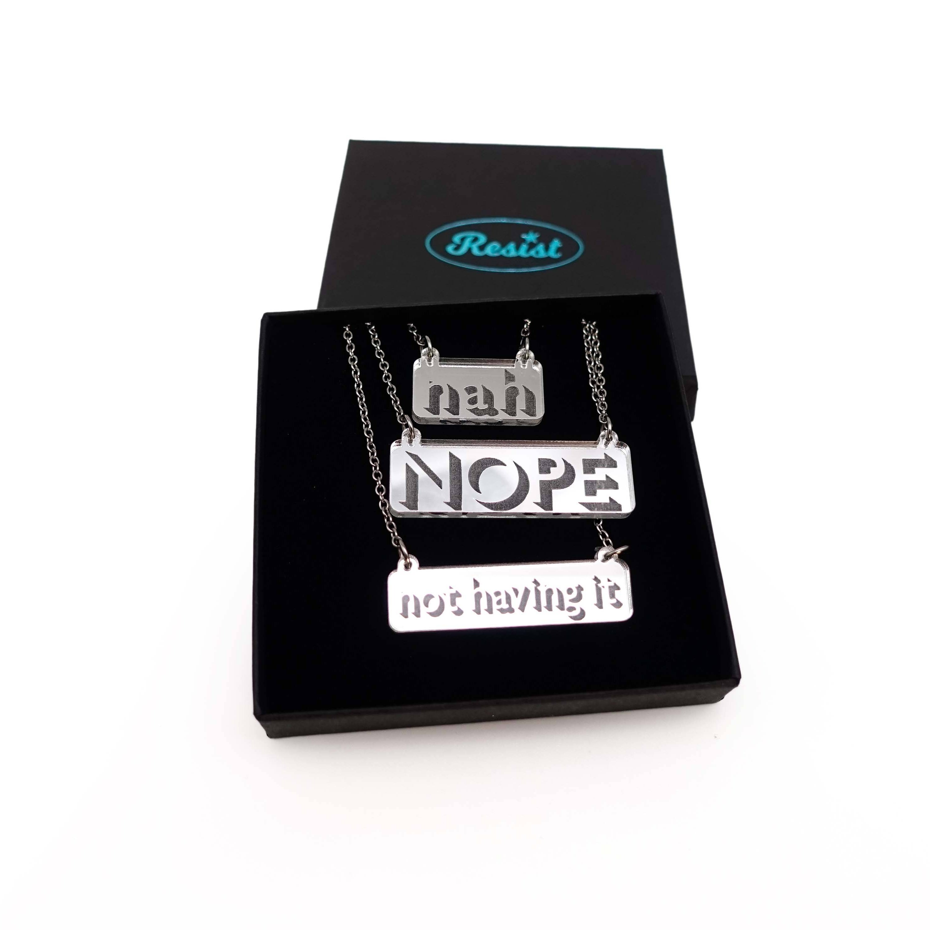 Nah, Nope and Not Having It necklaces in silver mirror on a stainless steel chain shown in a Wear and Resist gift box.