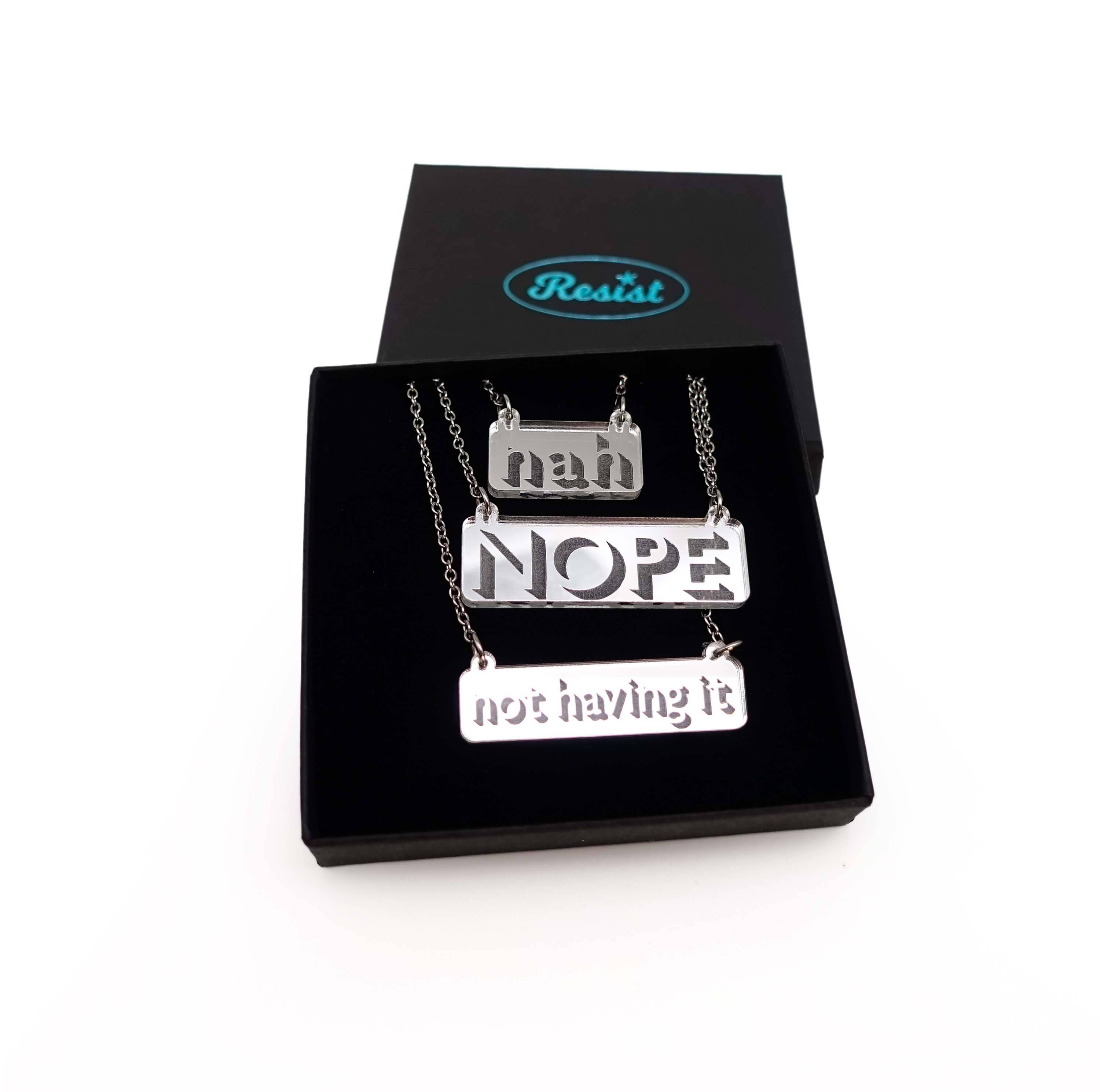 Nah, Nope and Not Having It necklaces in silver mirror on a stainless steel chain shown in a Wear and Resist gift box.