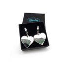 Nah Nope heart shaped huggie hoop earrings in silver mirror shown in a small Wear and Resist gift box.