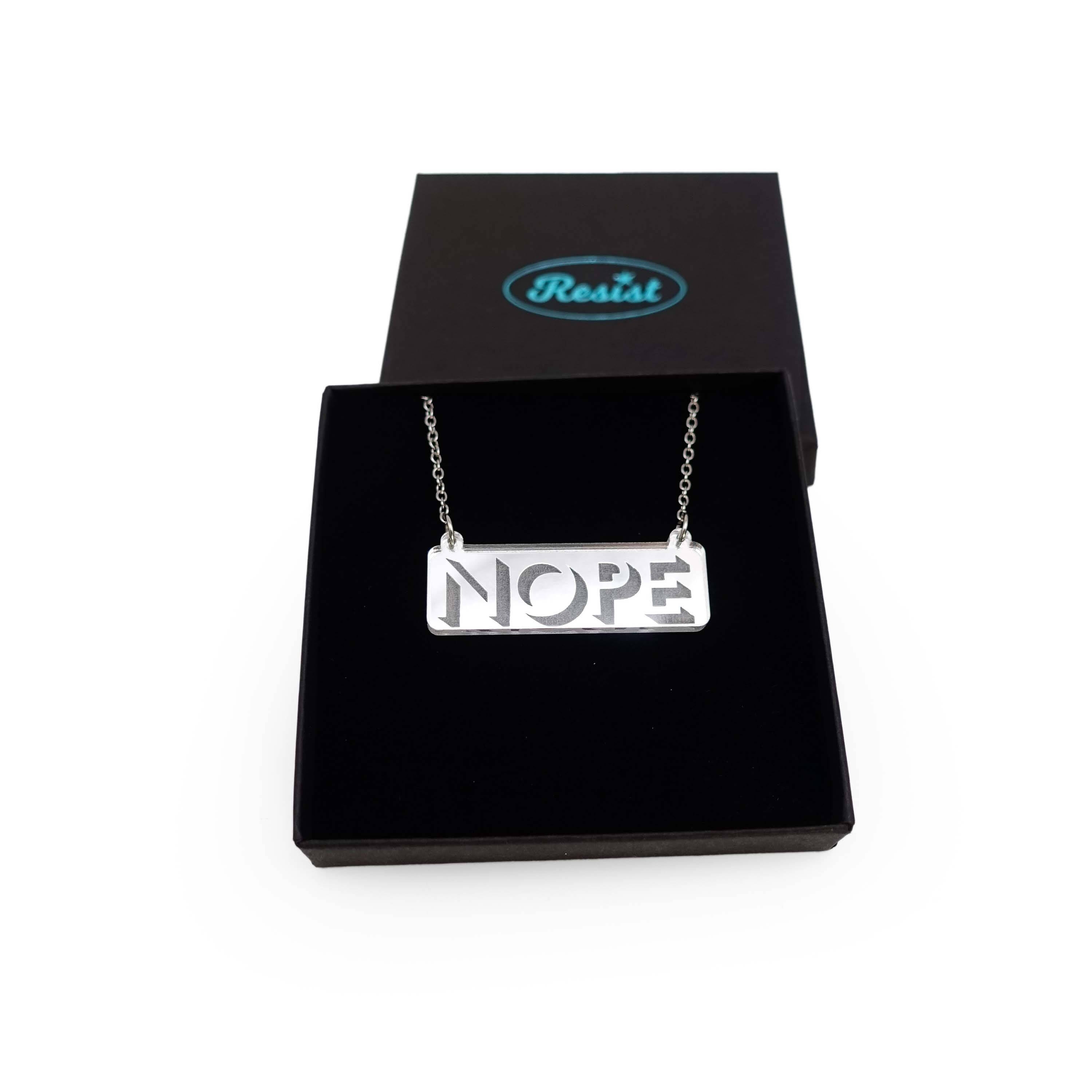 Nope necklace in silver mirror on a stainless steel chain shown in a Wear and Resist gift box.