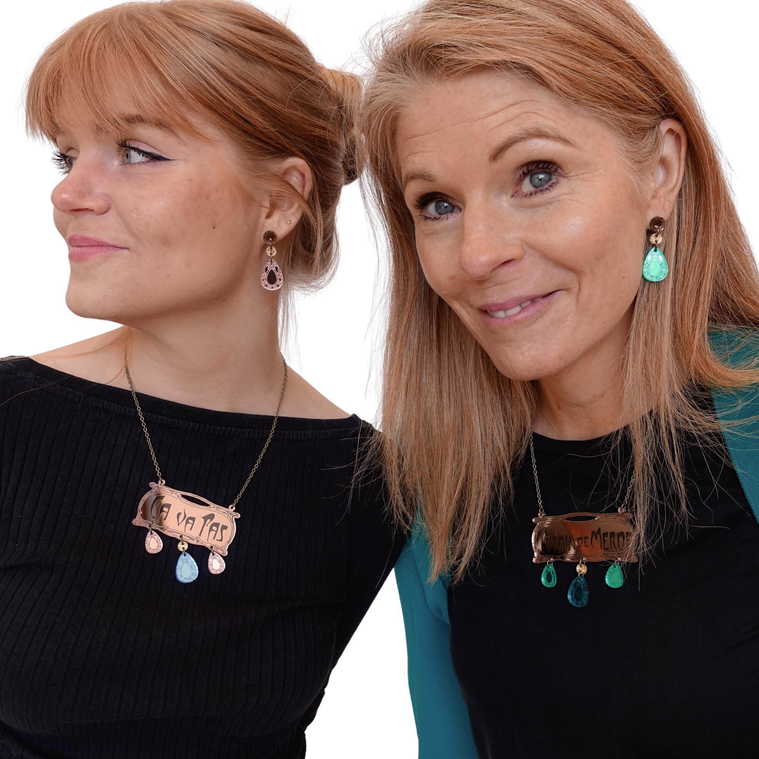 Eliza wearing the CA VA PAS necklace and rose gold Belle Epoque earrings while Sarah wears the French sweary P*taine de M*rde necklace and matching electric green Belle Epoque French drop earrings. £2 goes to Women for Refugee Women.  